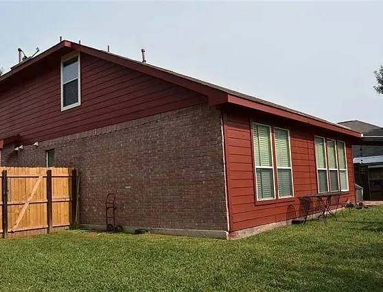 View of side of property with a gate