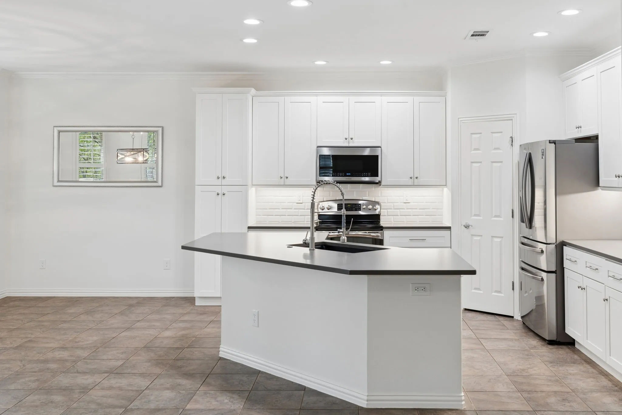 Gourmet kitchen with beautifully designed backsplash and custom cabinets