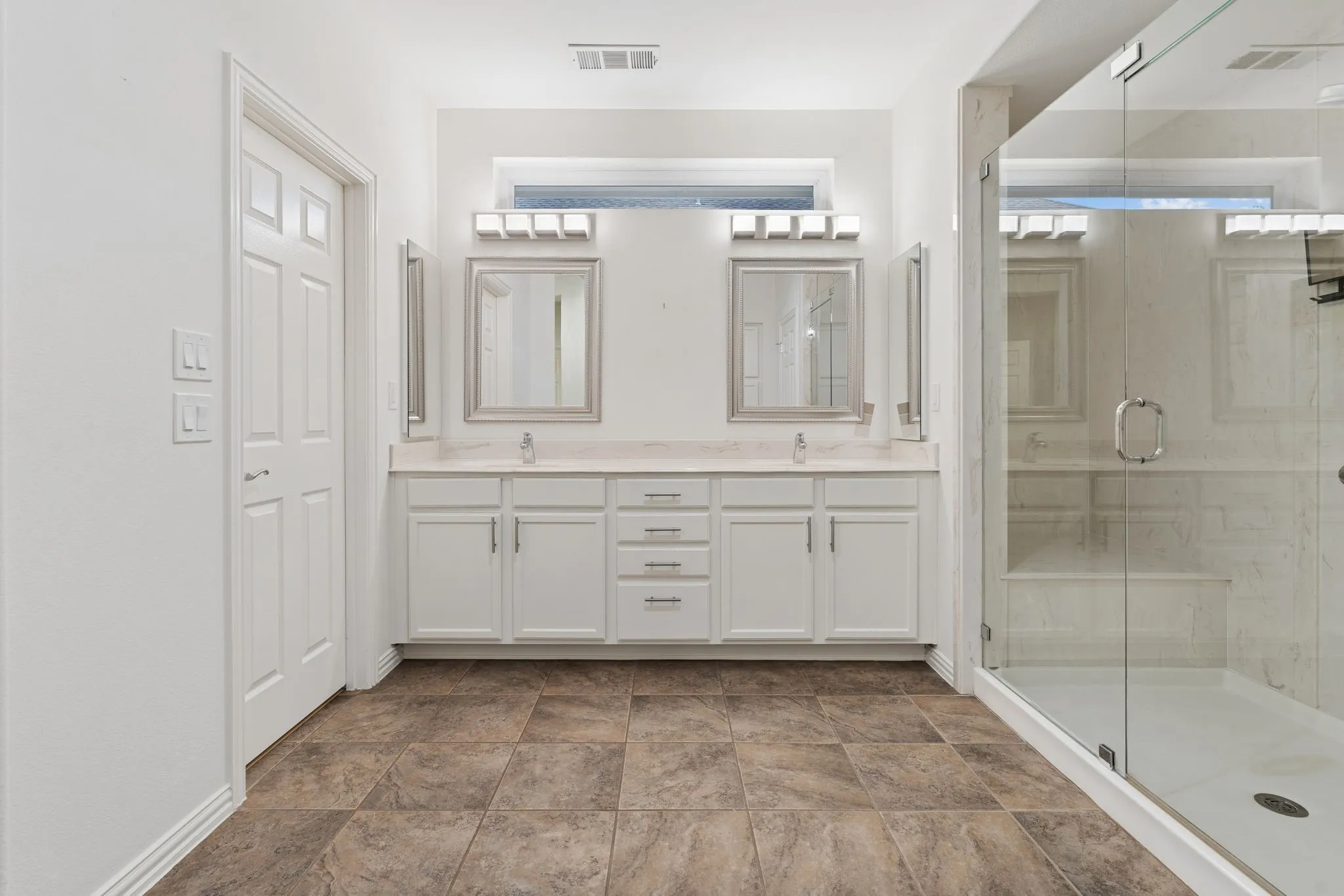 Large walk in closet and the window on the vanity wall provide natural light for getting ready