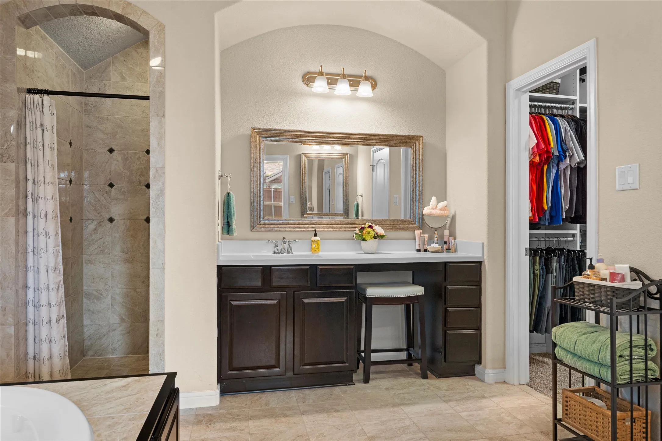 Dual vanities, separate shower and tub, and walk-in closet