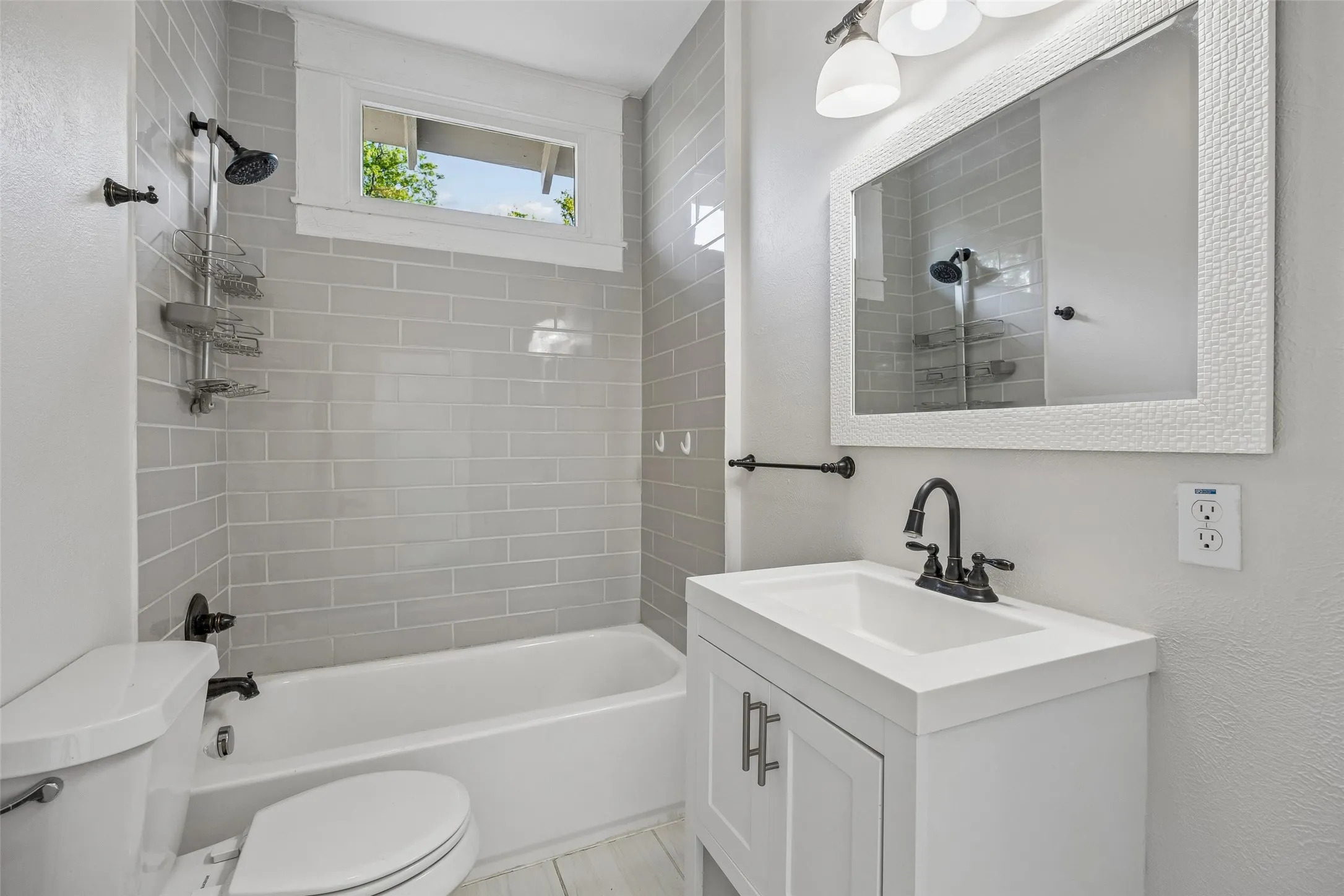 The second story bath is crisply furnished in soothing grey and white.