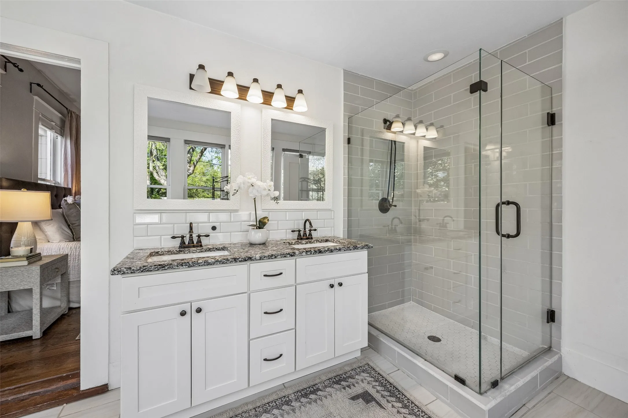 Crisp and white. Double sinks with plenty of storage...and an oversized shower!