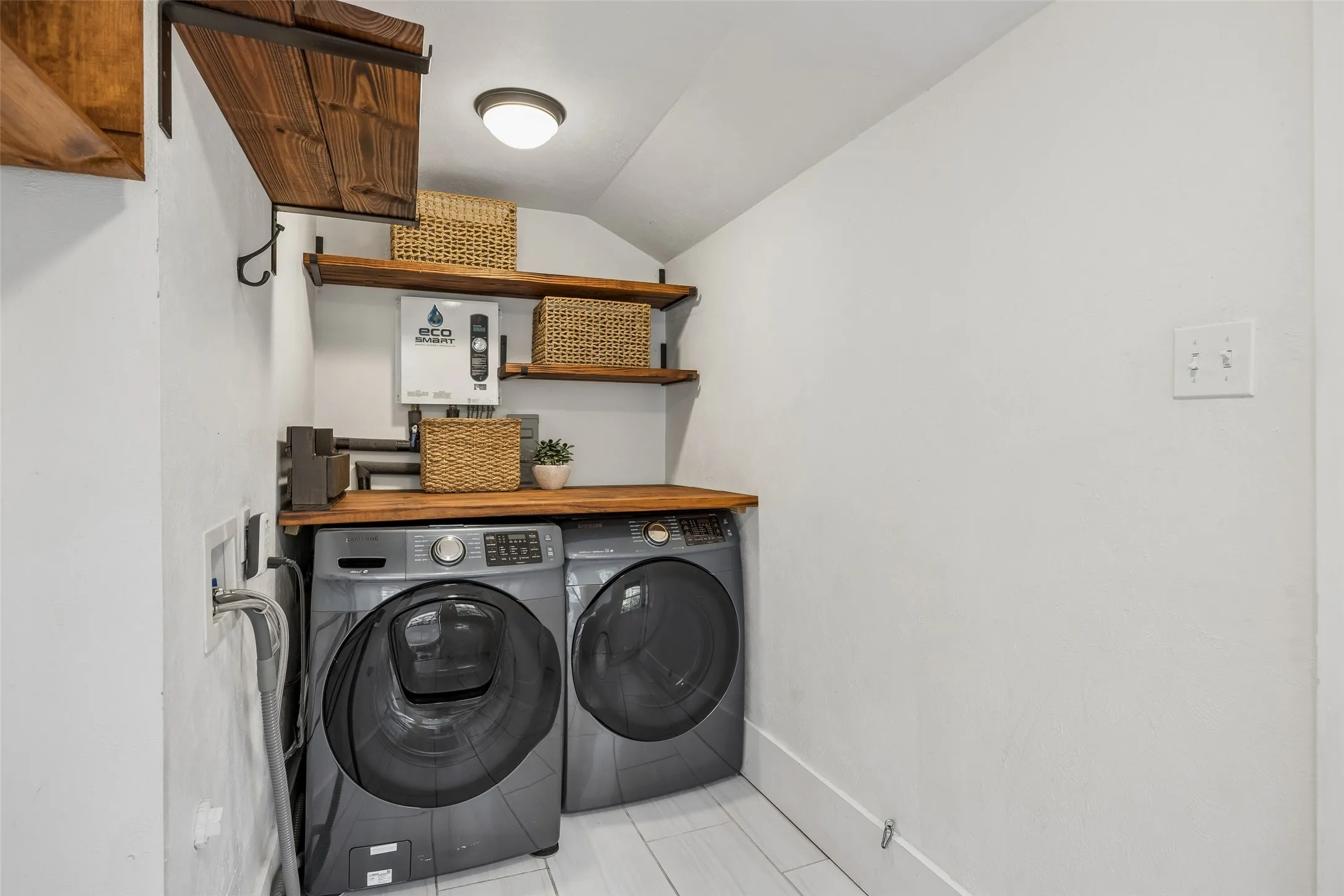 A super laundry room with floating shelves and a folding table. What a luxury in a vintage home.