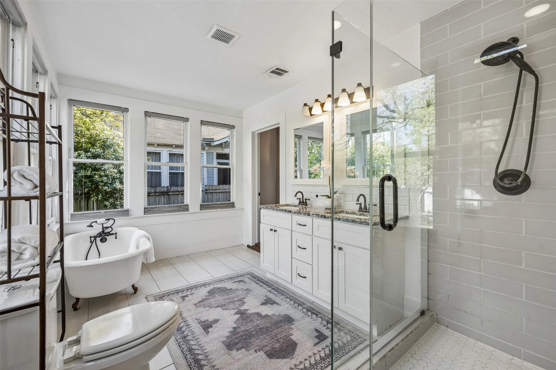 The clawfoot tub is a charming nod to days gone by....but fantastic for a deep soaker. Window shades offer plenty of privacy.