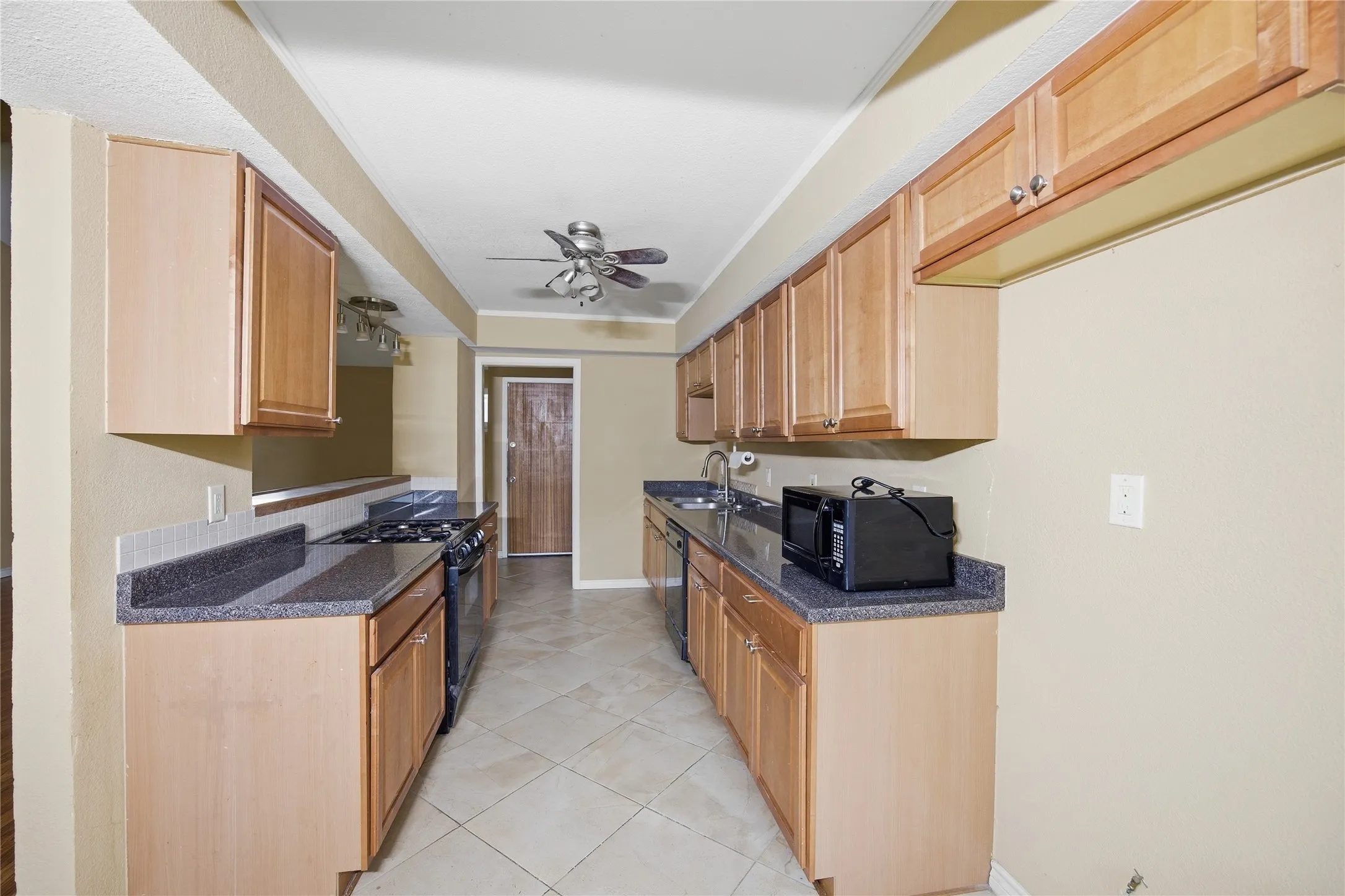 This galley style kitchen is great for access to the appliances, counter space & water.