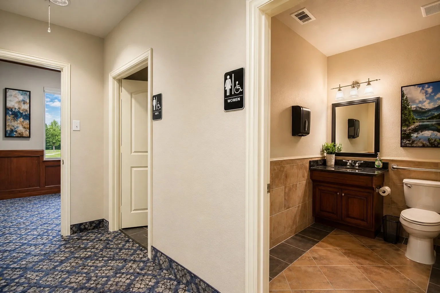 Restroom featuring a dark wood vanity with a black countertop, wall-mounted mirror, and three-light fixture