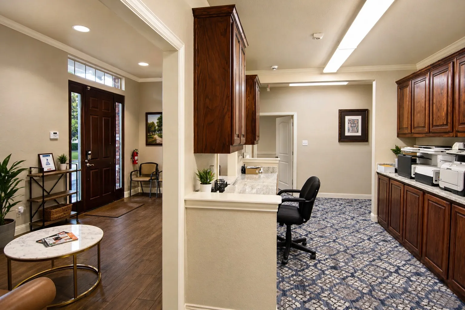 Entry foyer with wood-finish flooring and a paneled front door with sidelights and transom window
