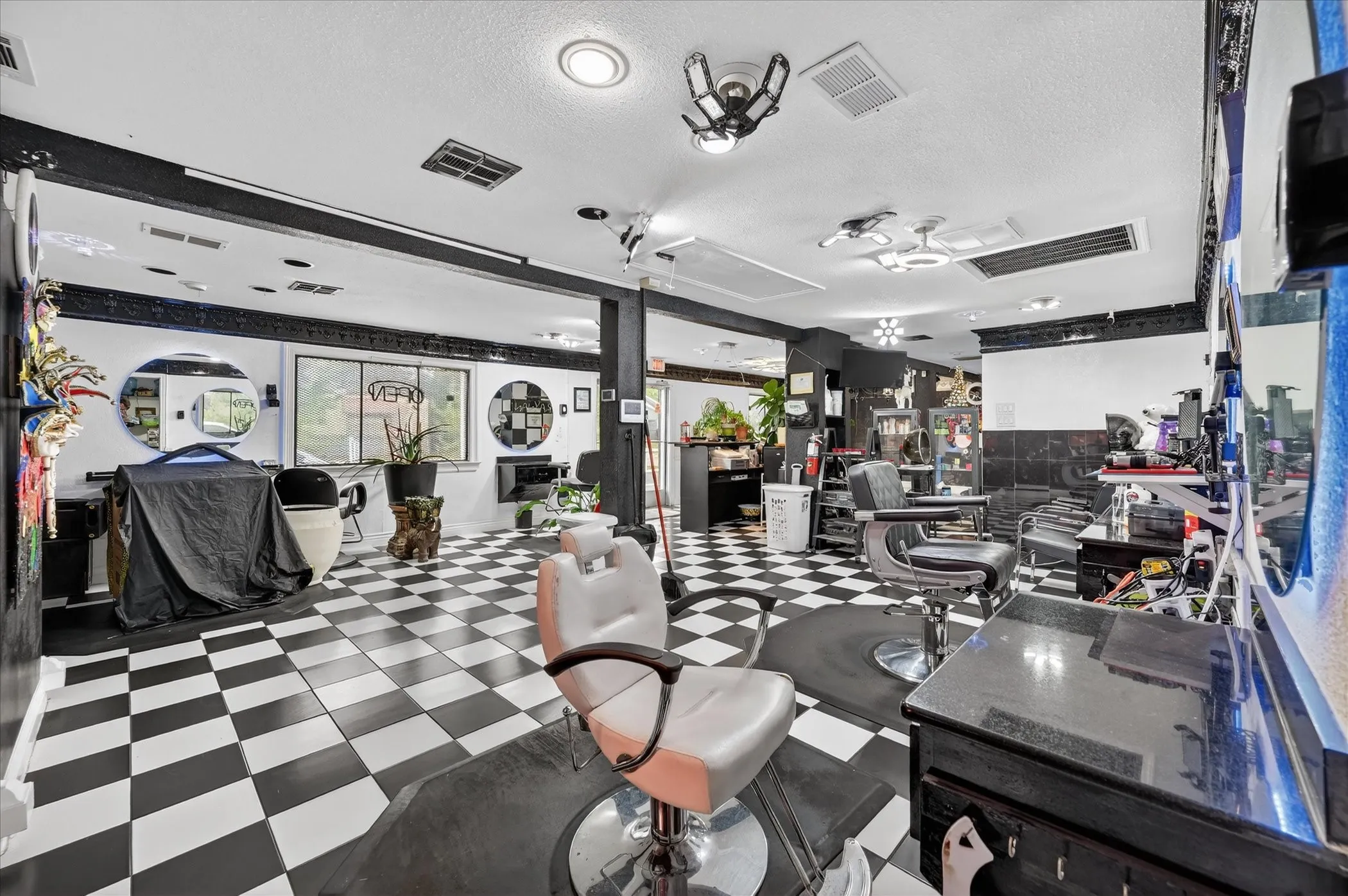 Open salon area with multiple styling stations and seating.