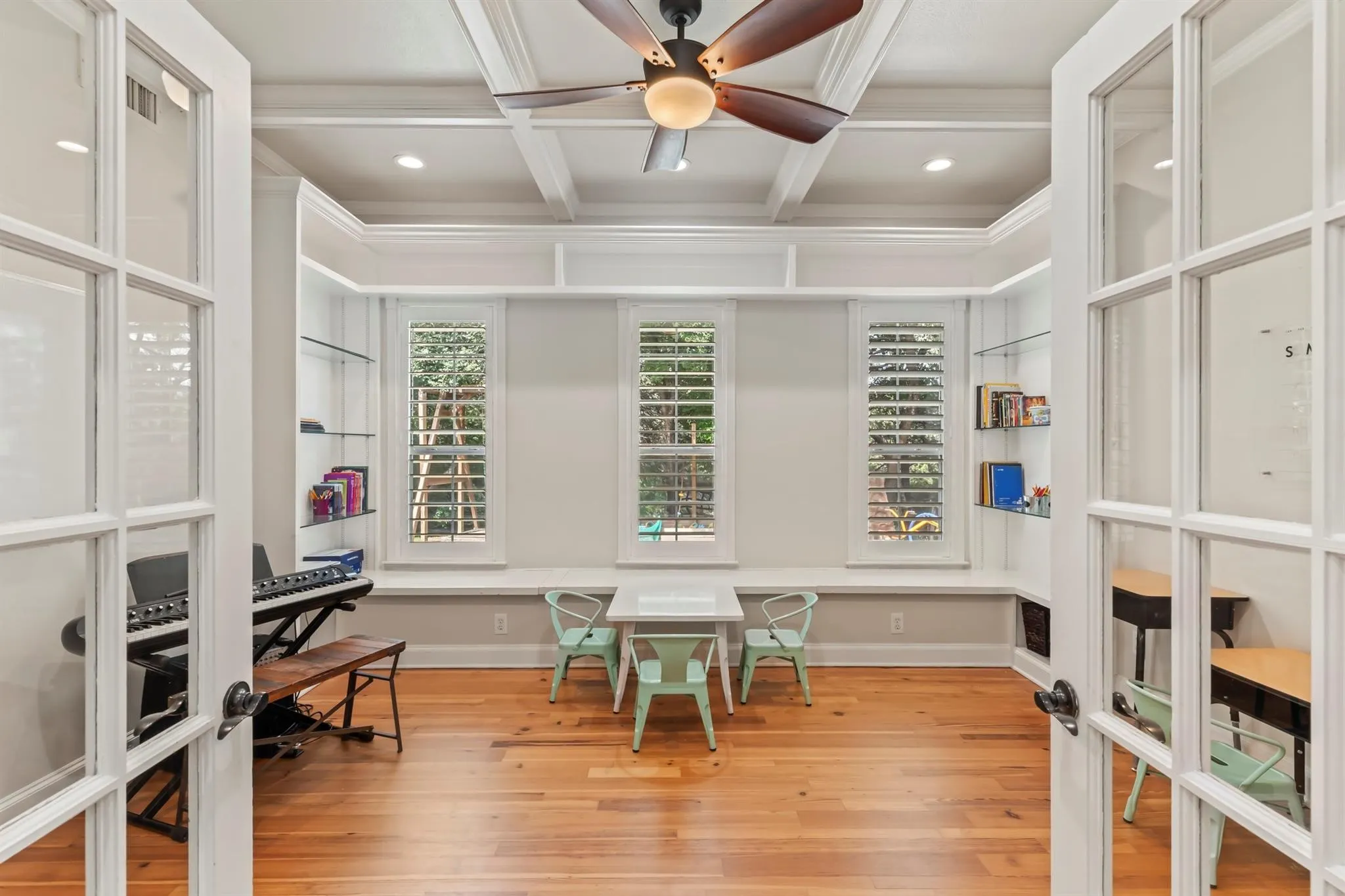Office space with french doors, light wood-style flooring, coffered ceiling, recessed lighting, and ceiling fan