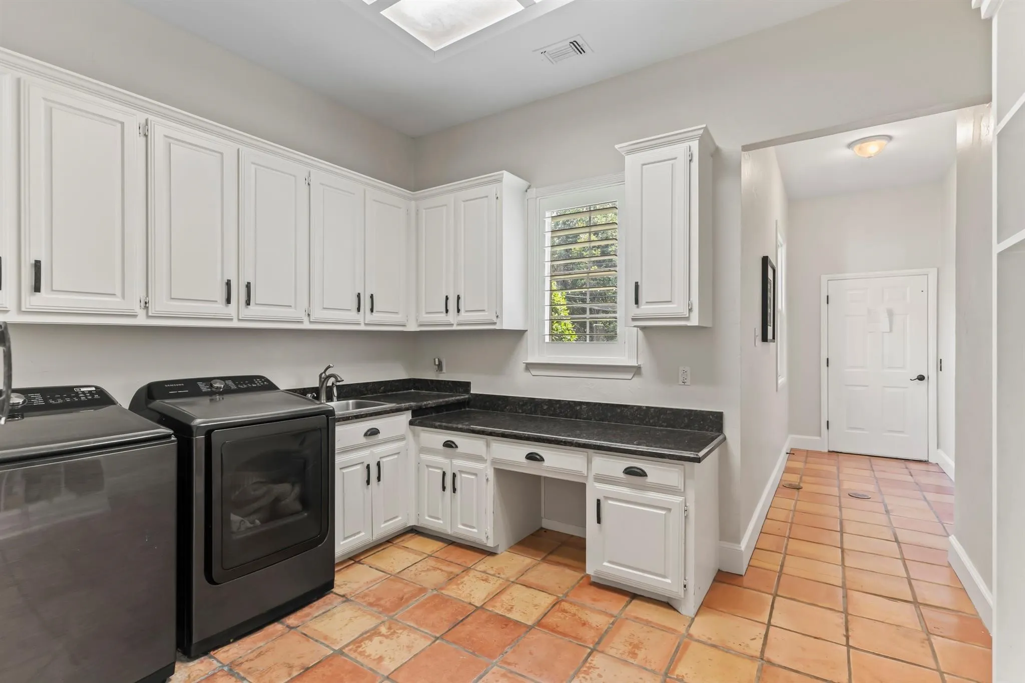 Laundry room featuring separate washer and dryer and cabinet space