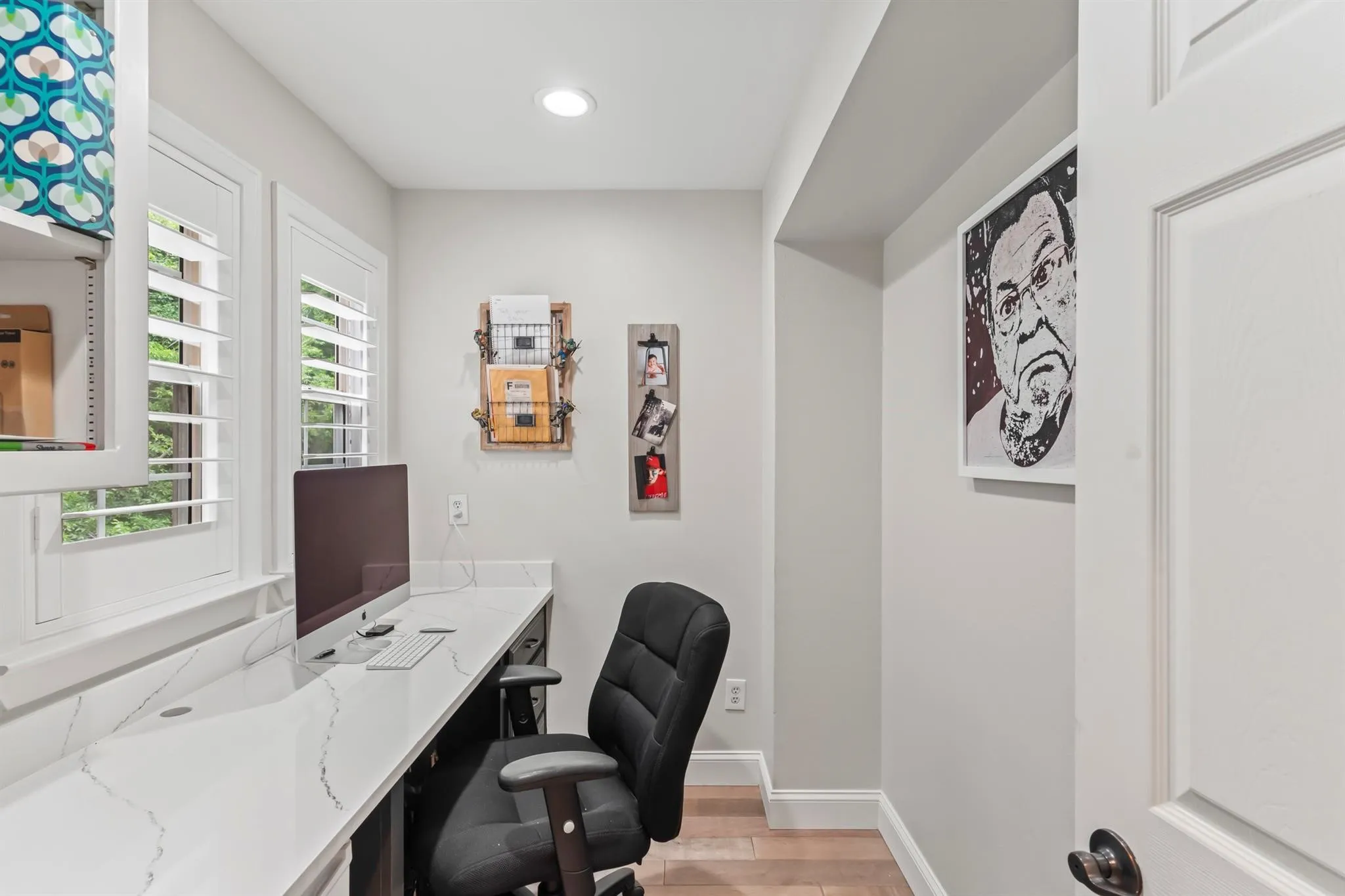 Home office with light wood-type flooring and recessed lighting