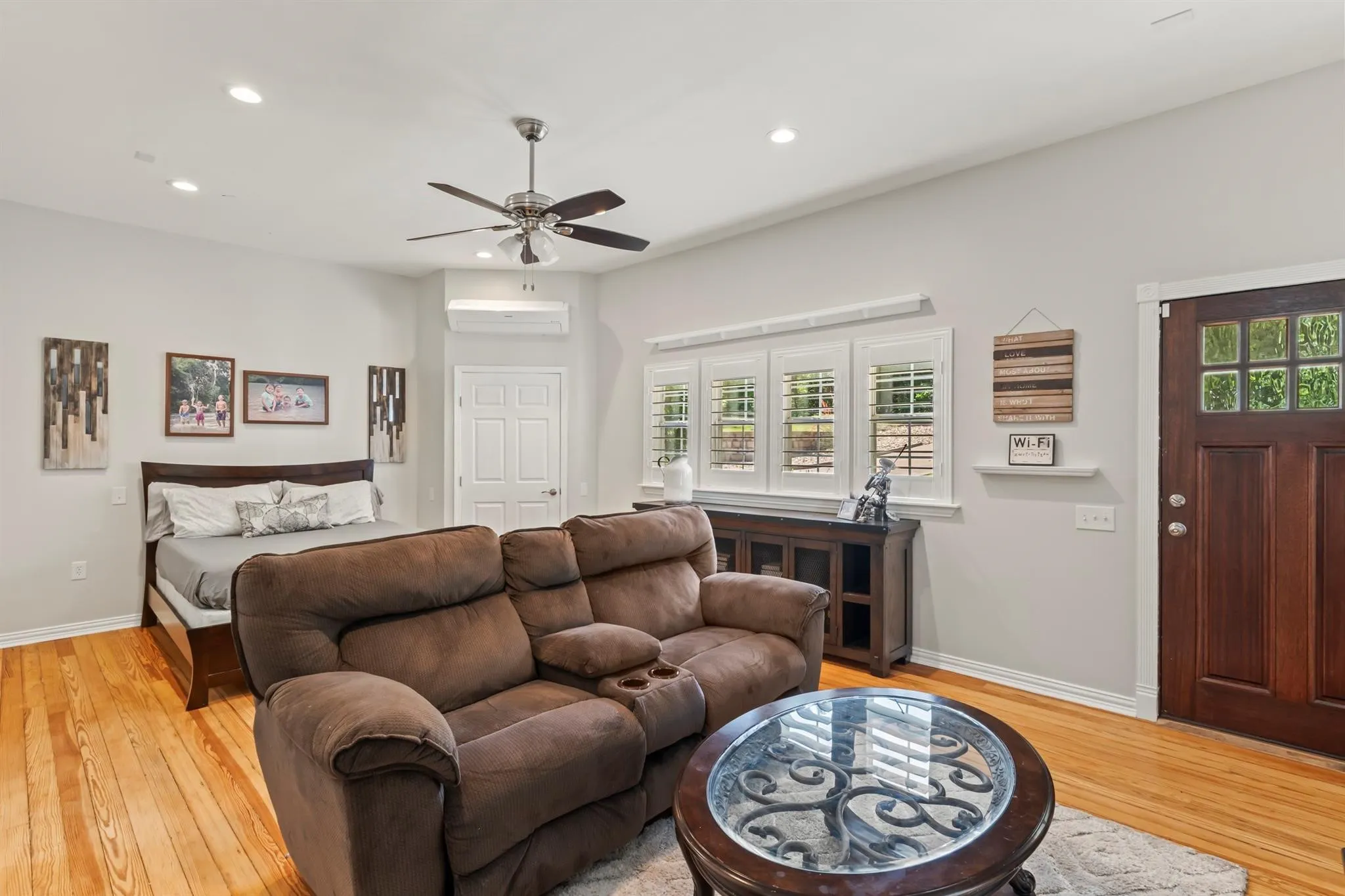 Bedroom with light wood-type flooring, recessed lighting, and a ceiling fan