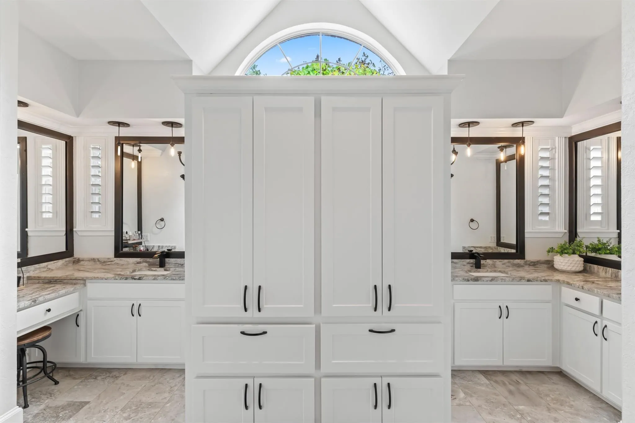 Full bathroom featuring plenty of natural light and two vanities