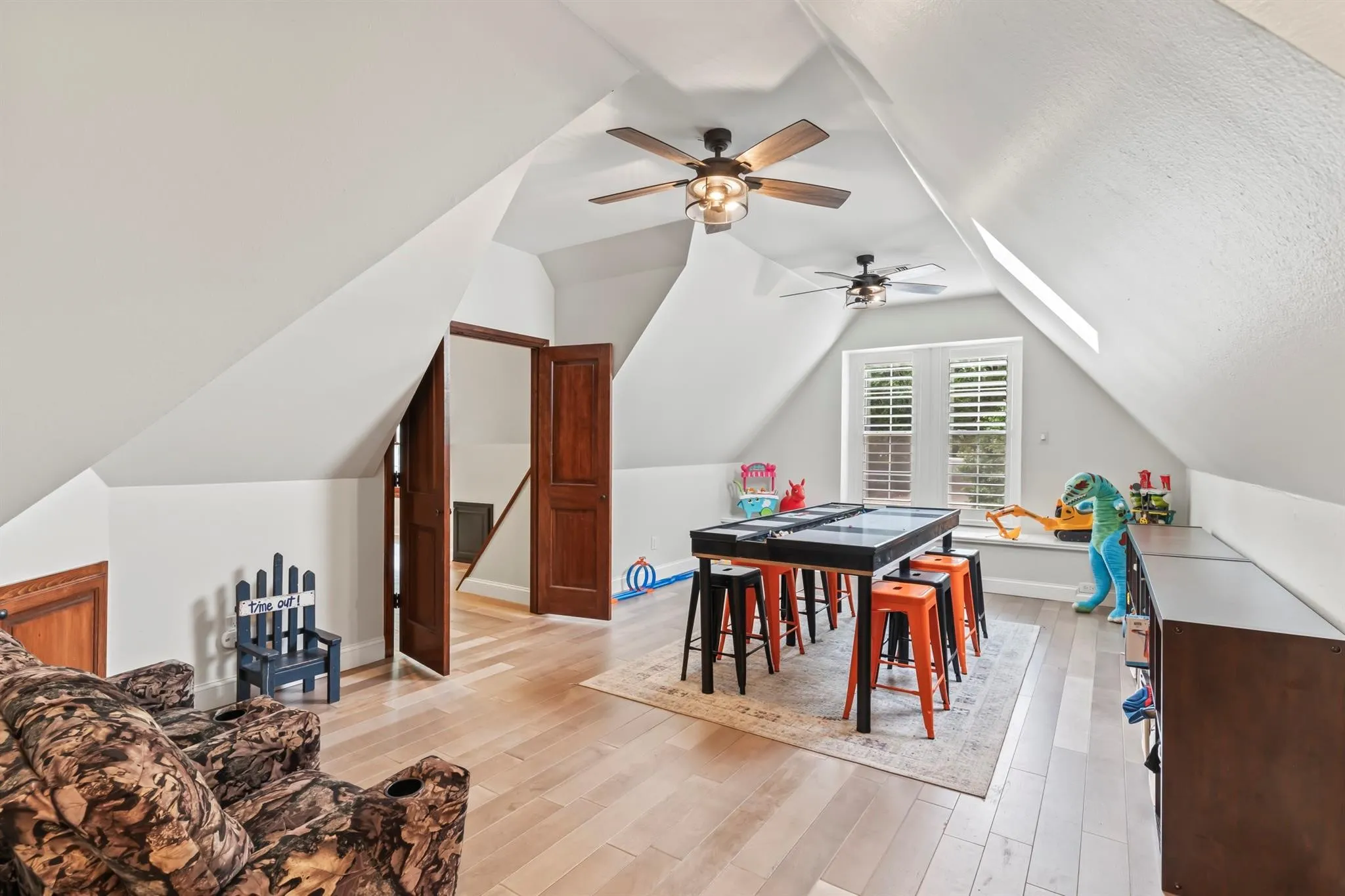 Game room with light wood-type flooring and a ceiling fan