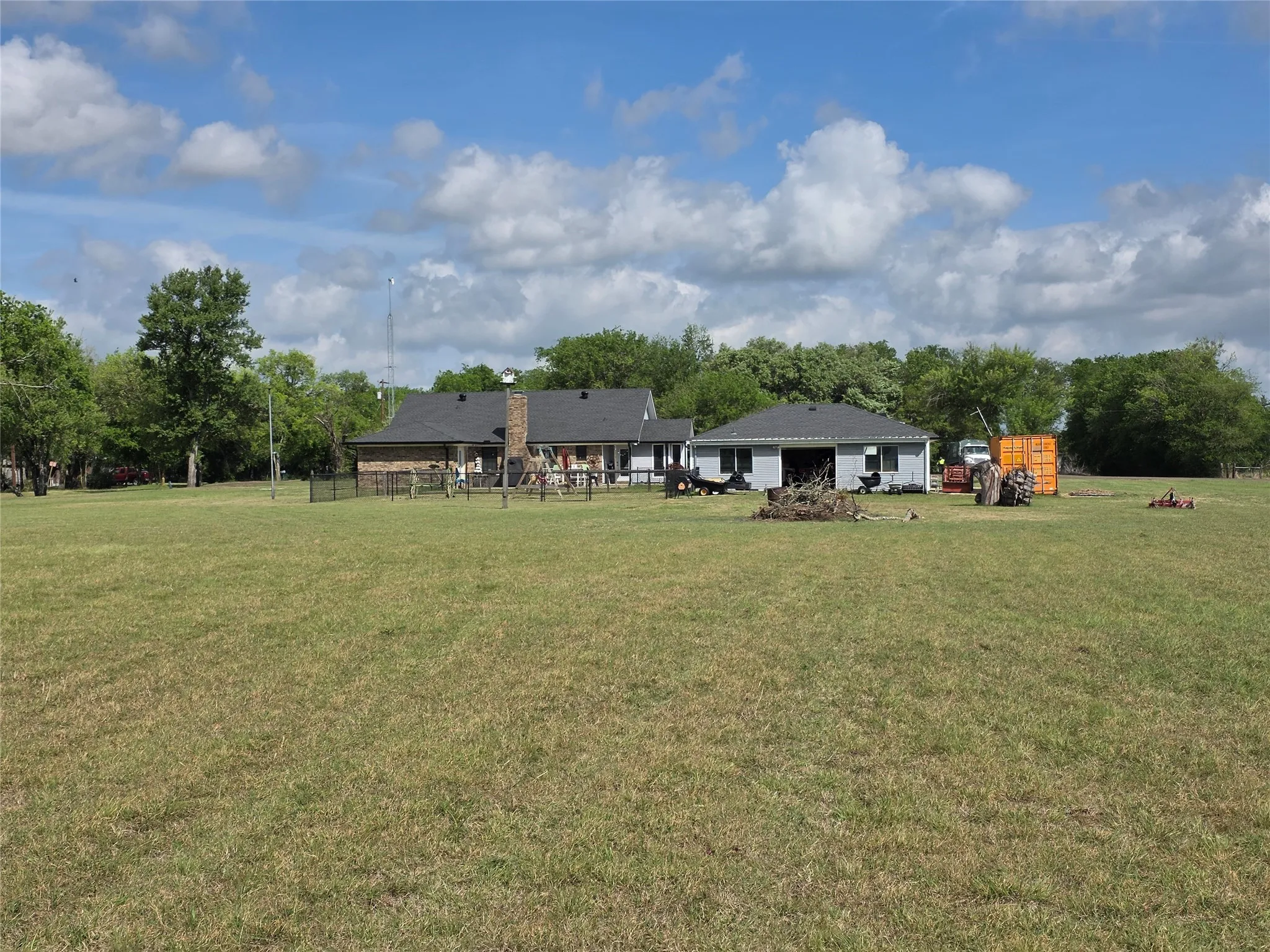 View of grassy yard featuring view of wooded area