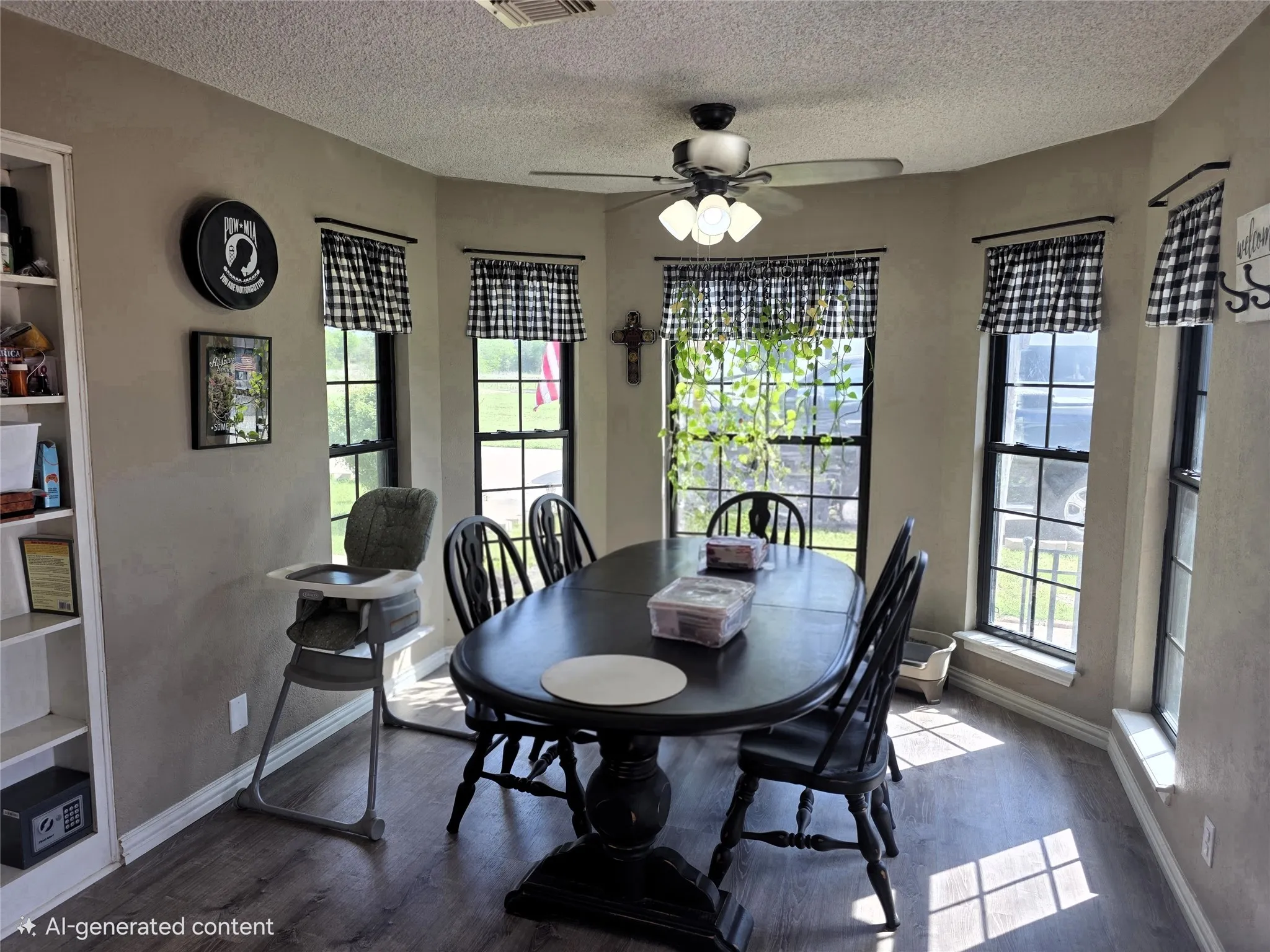 Dining space featuring wood finished floors, plenty of natural light, a textured ceiling, and a ceiling fan