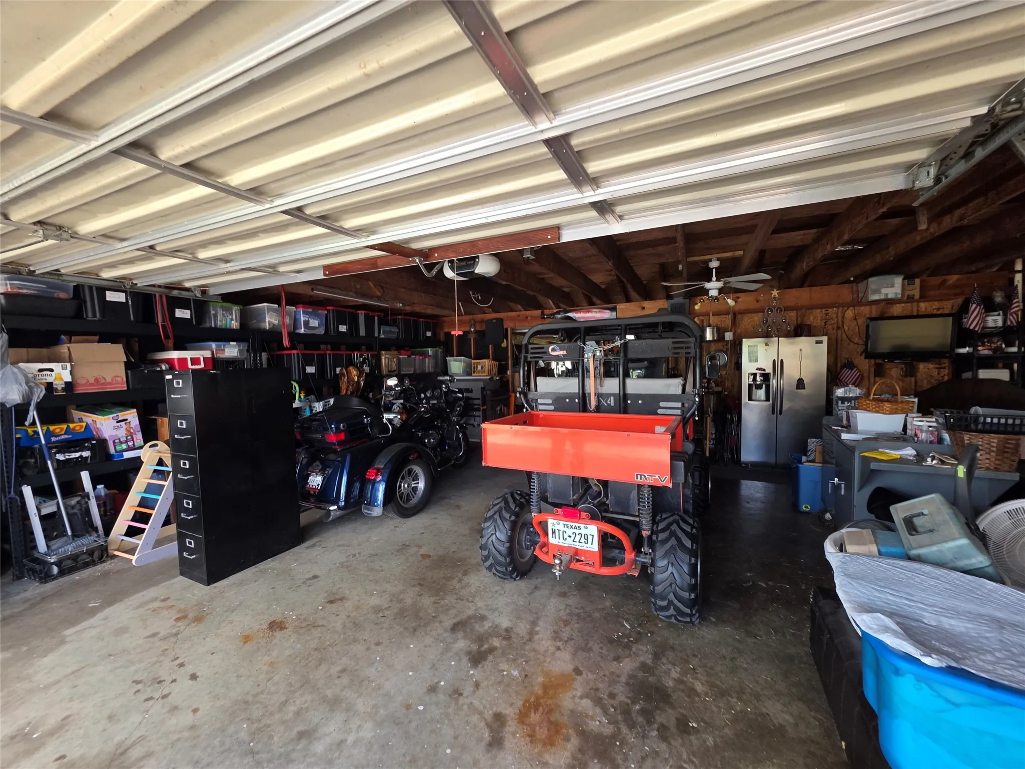 Garage with stainless steel fridge with ice dispenser