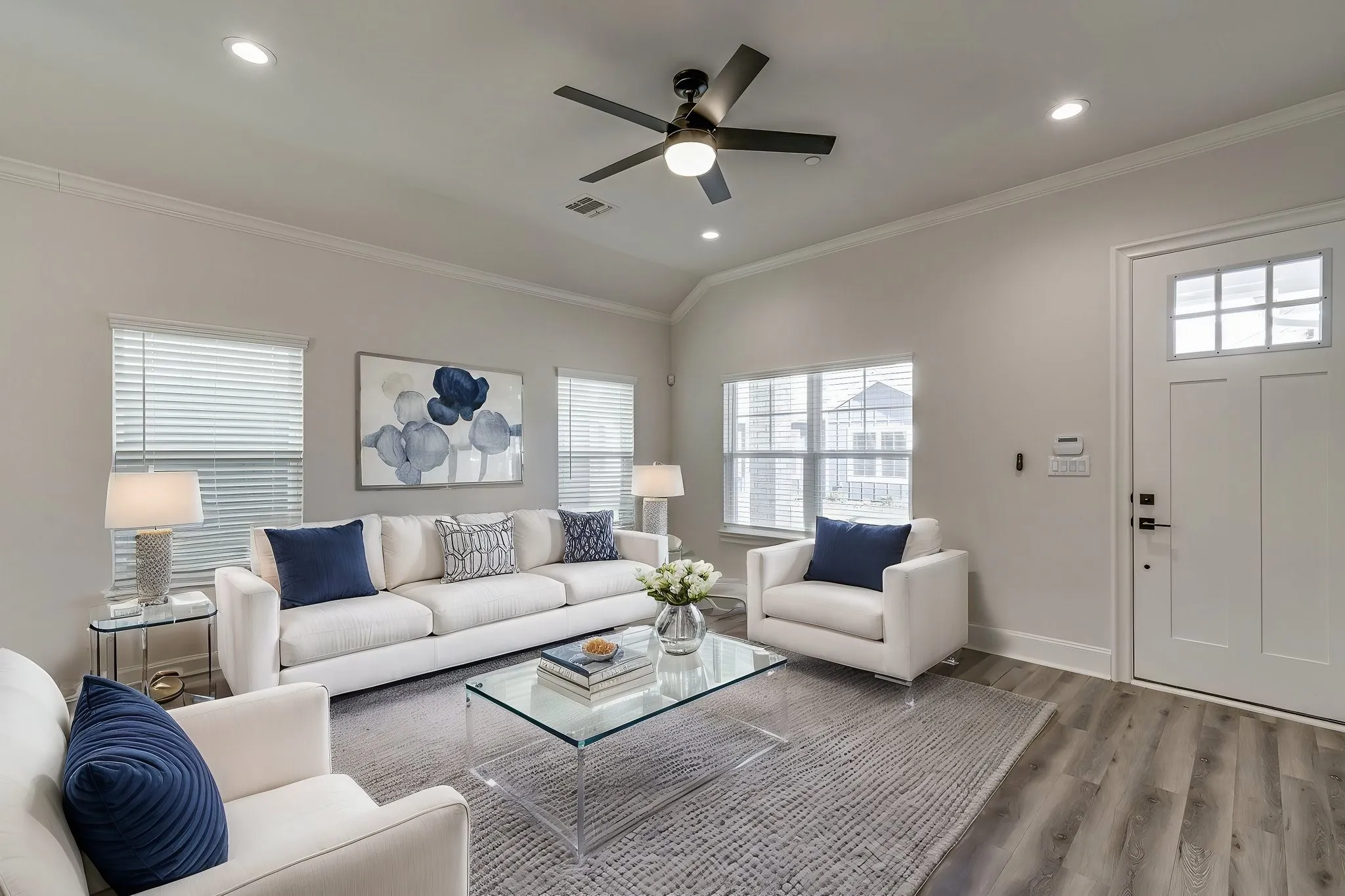 Living area featuring ceiling fan, ornamental molding, recessed lighting, wood finished floors, and lofted ceiling