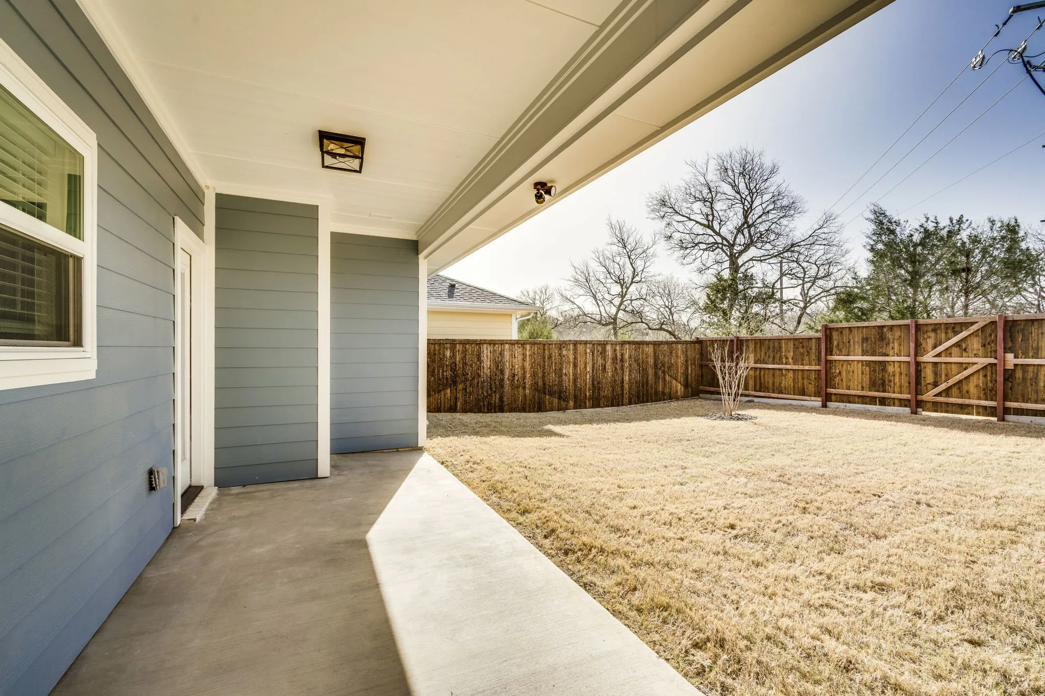 Fenced backyard featuring a patio