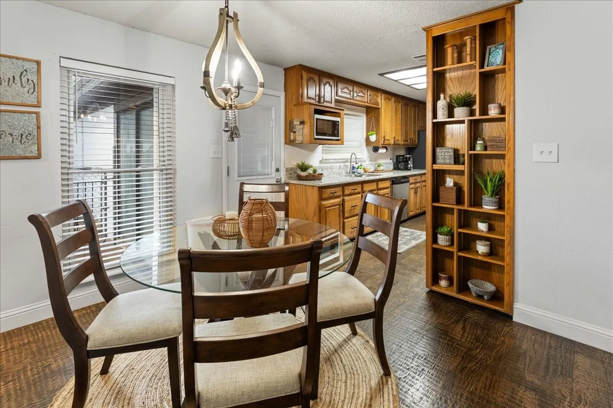 Dining area with baseboards and a textured ceiling