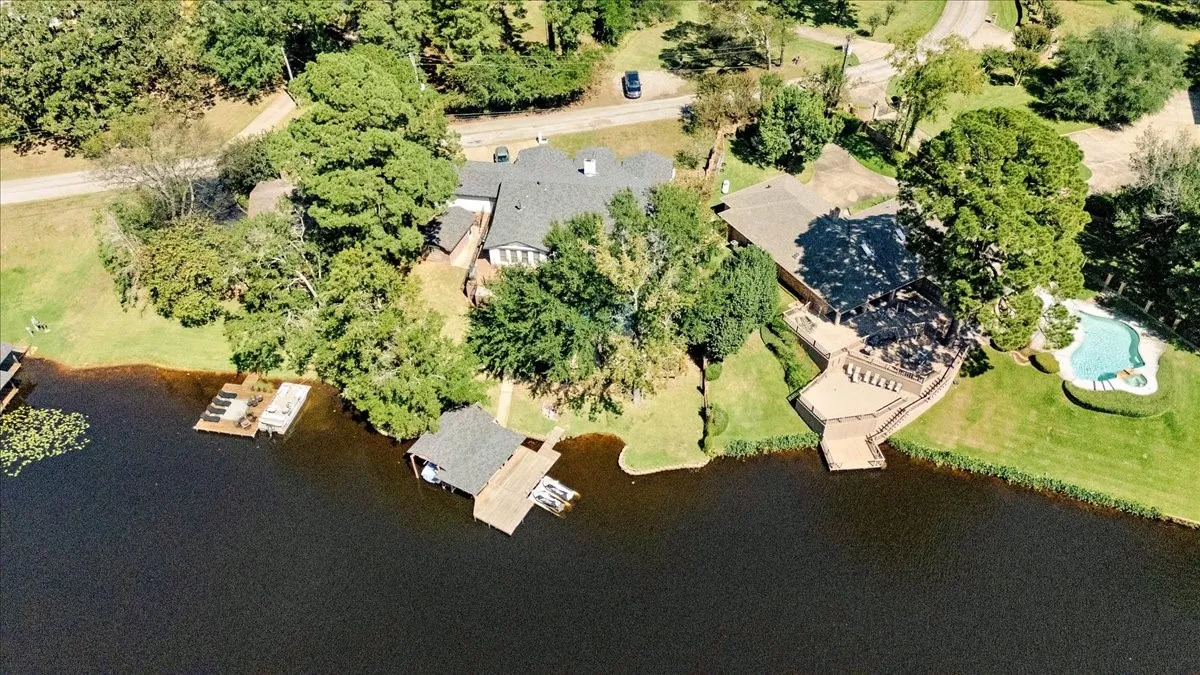Aerial view of property and surrounding area with a large body of water