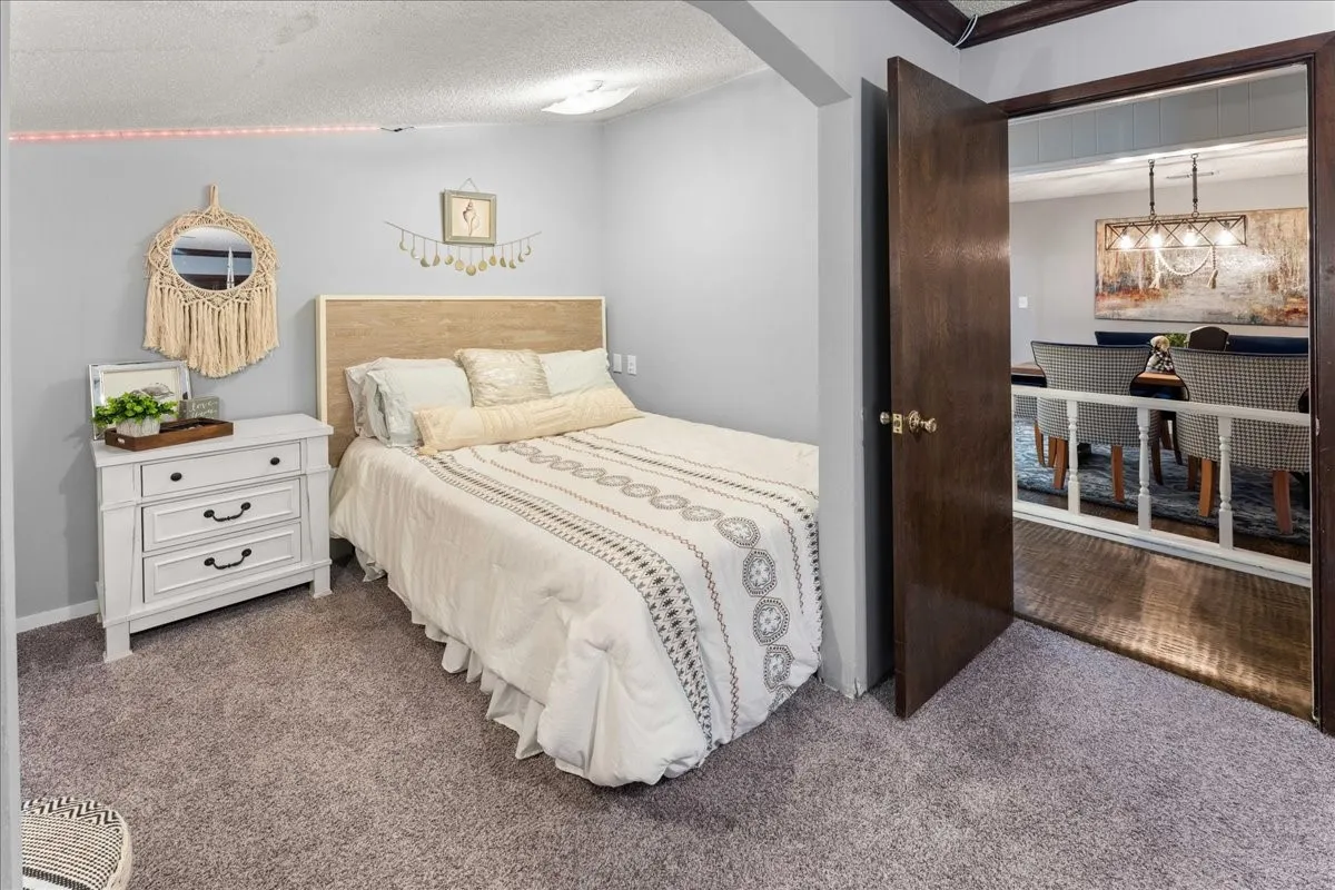 Carpeted bedroom featuring a textured ceiling