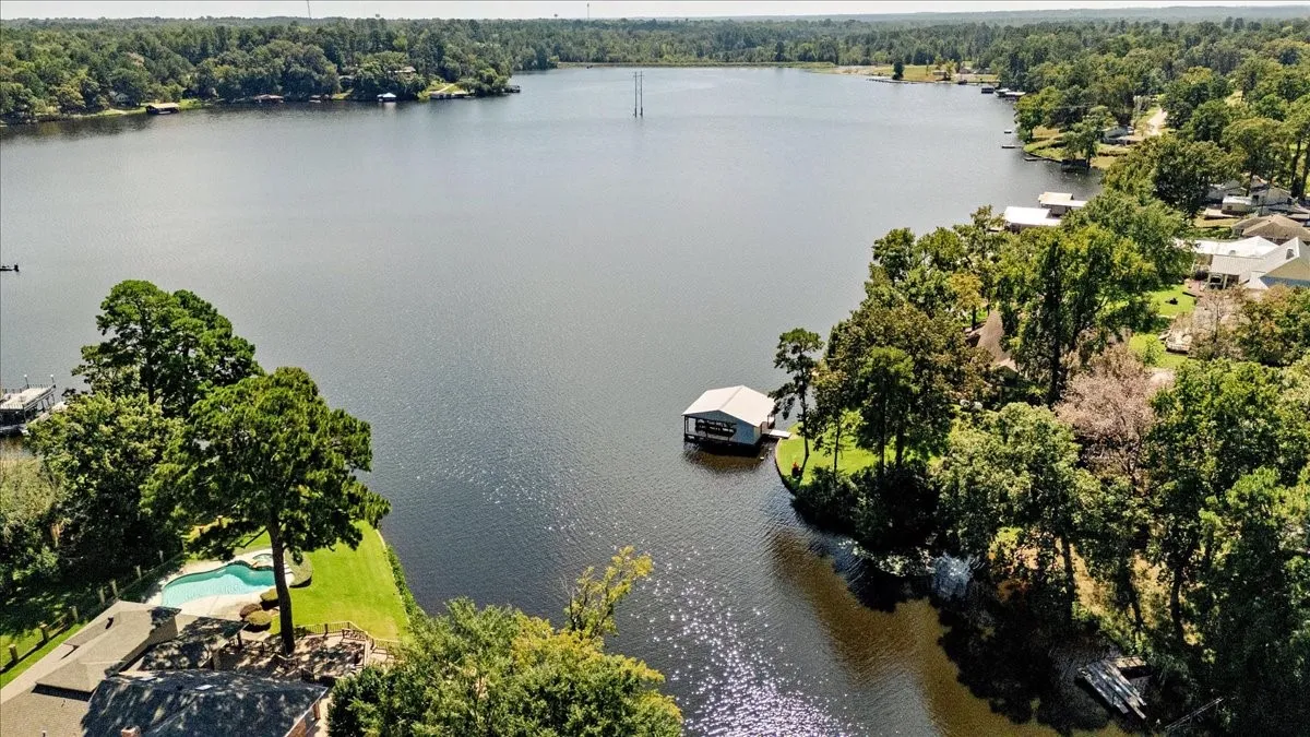 Bird's eye view of a nearby body of water and a heavily wooded area
