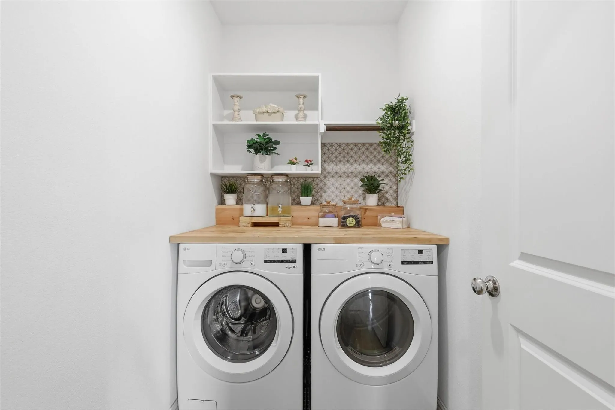 Updated laundry room with washing machine and dryer and storage