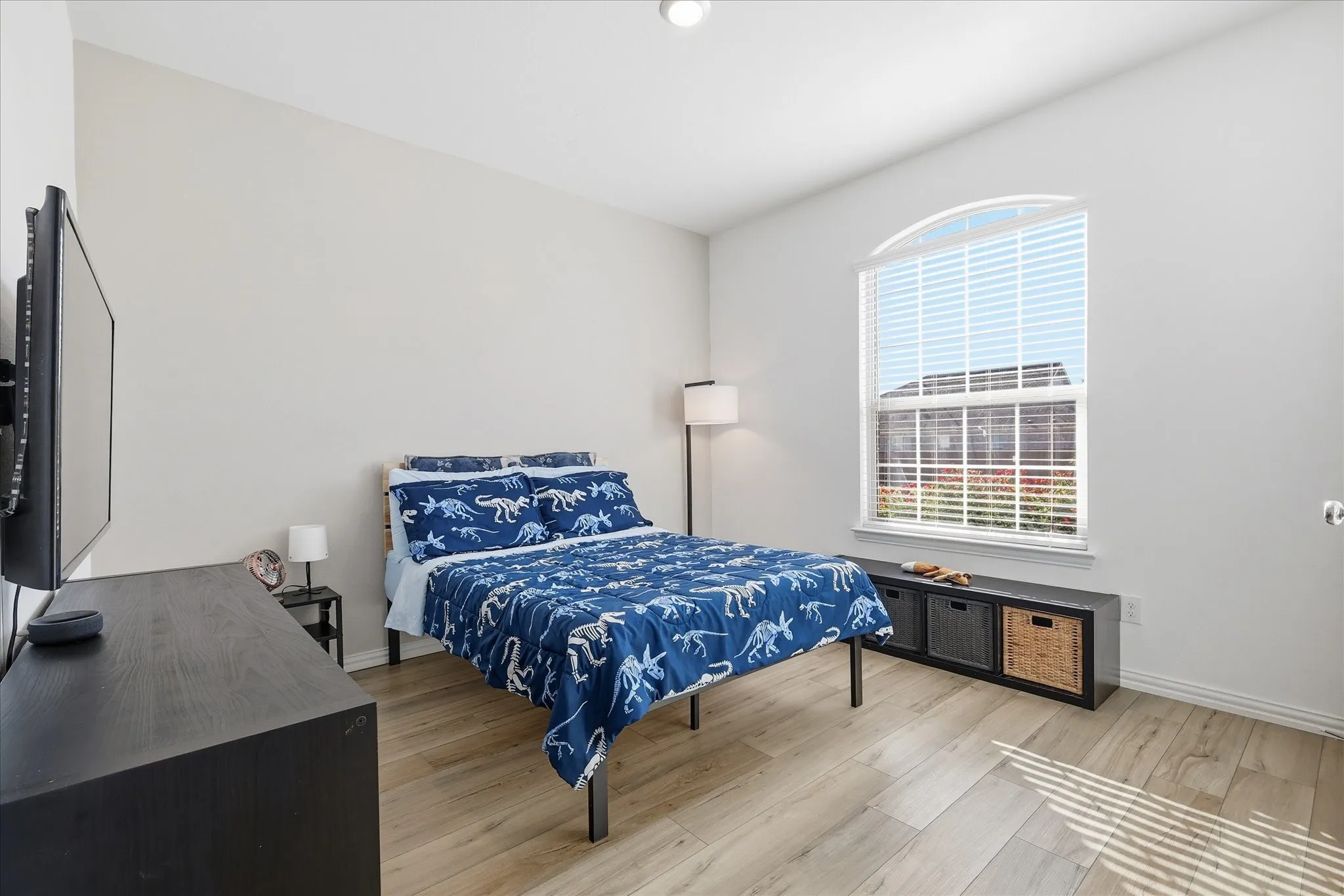 Secondary bedroom with light luxury vinyl
in flooring and baseboards