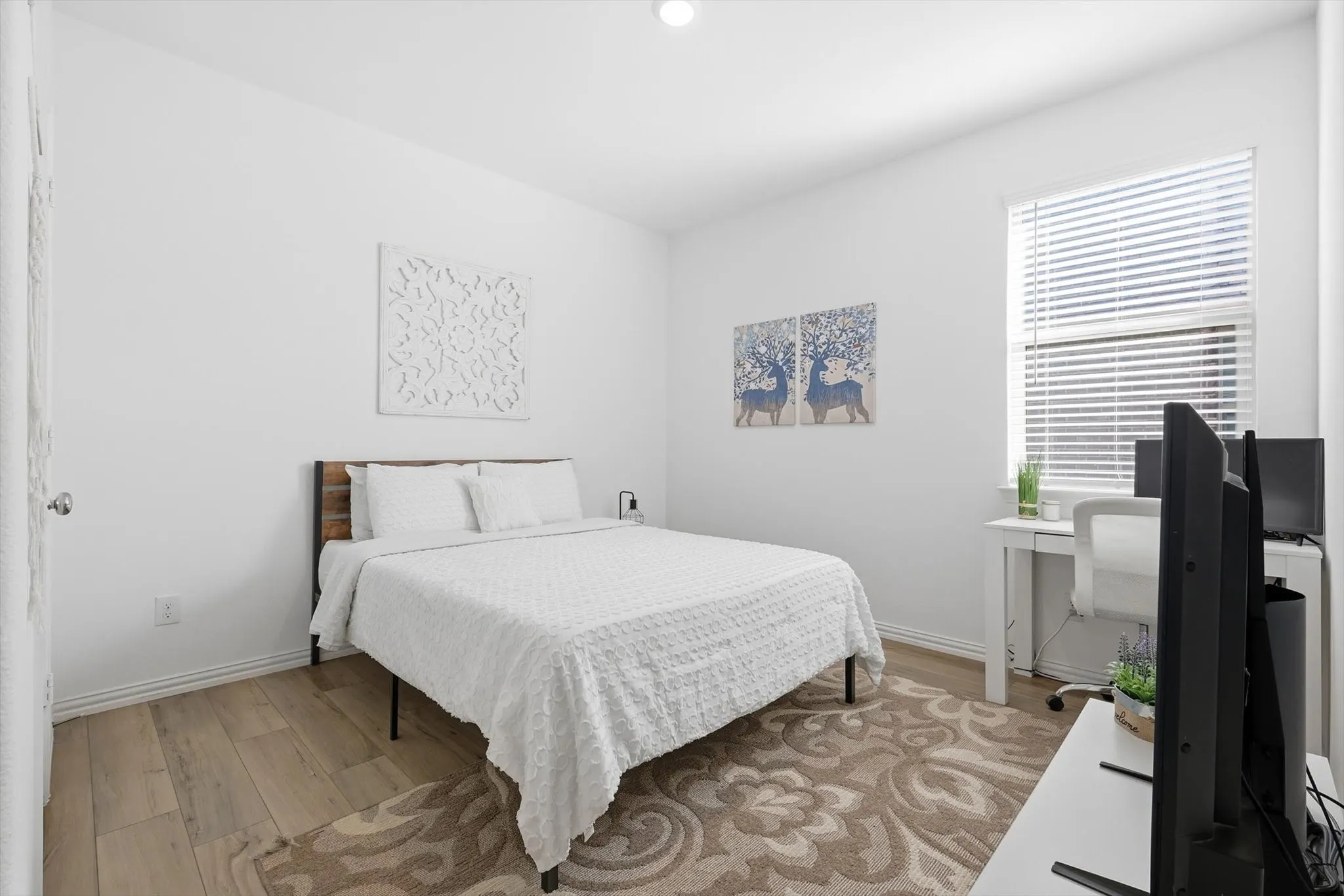 Secondary bedroom featuring light LVP flooring and baseboards