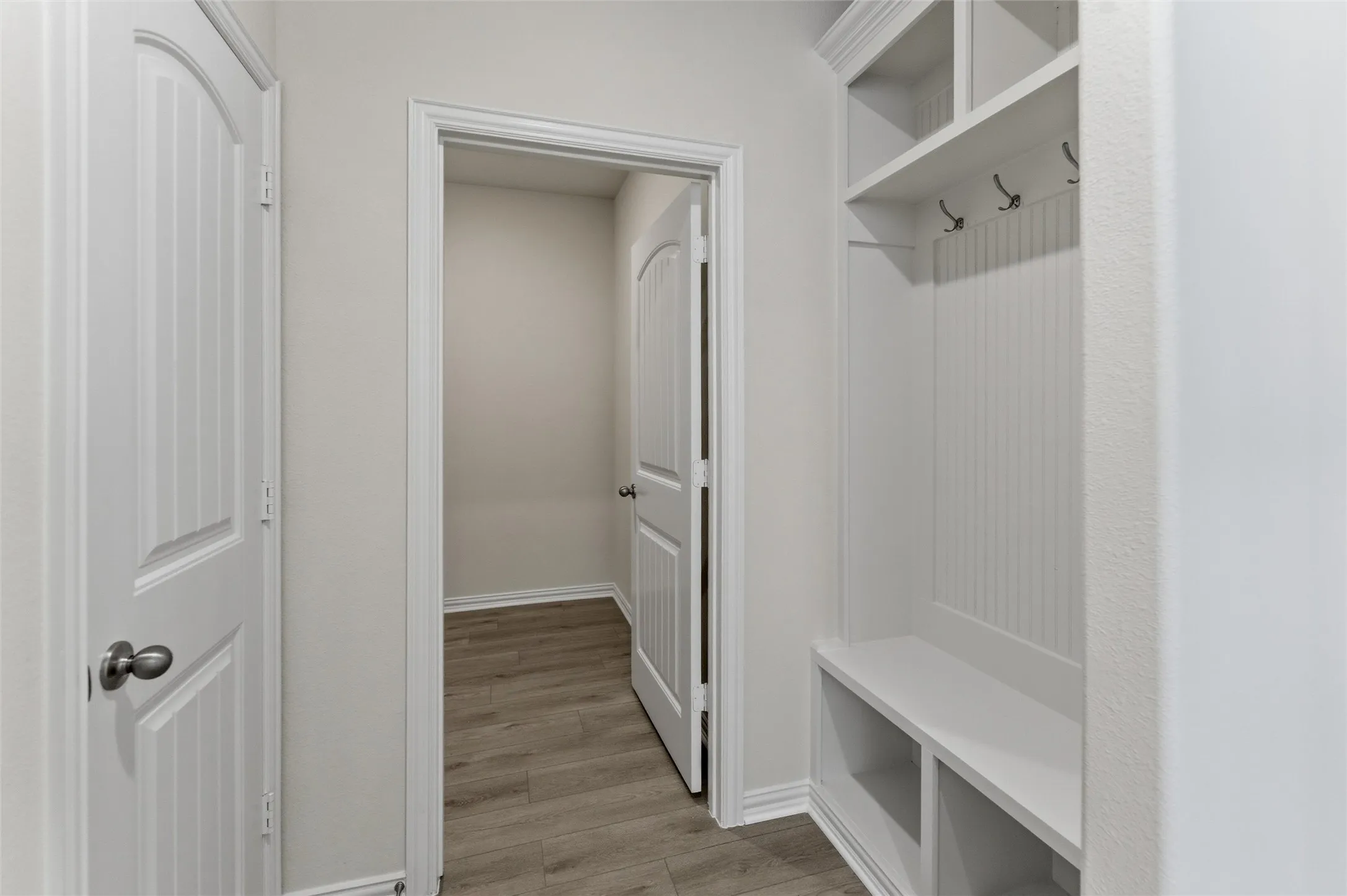 Mudroom featuring light wood-type flooring and baseboards