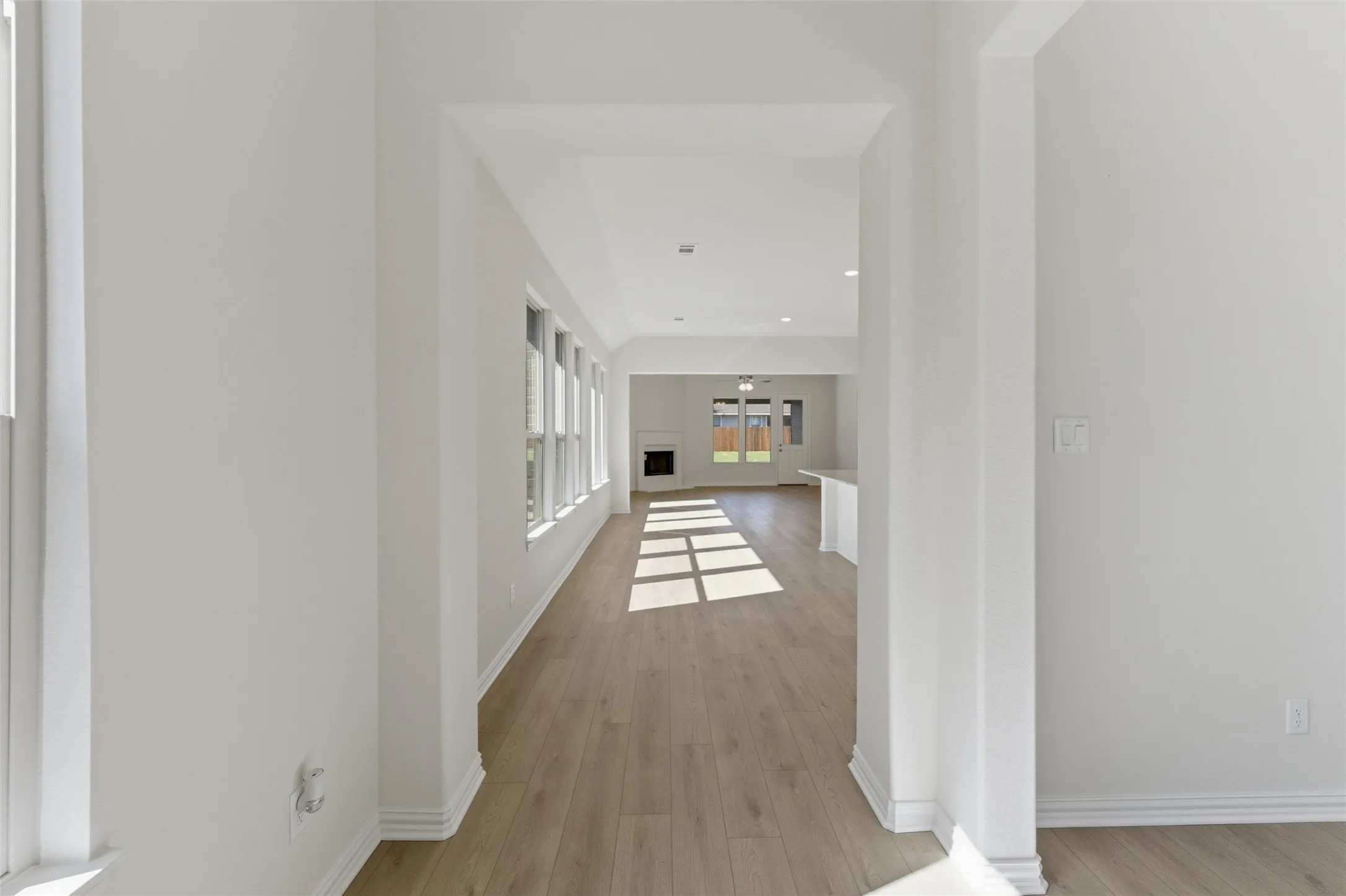 Hallway with light wood-style floors, recessed lighting, and french doors