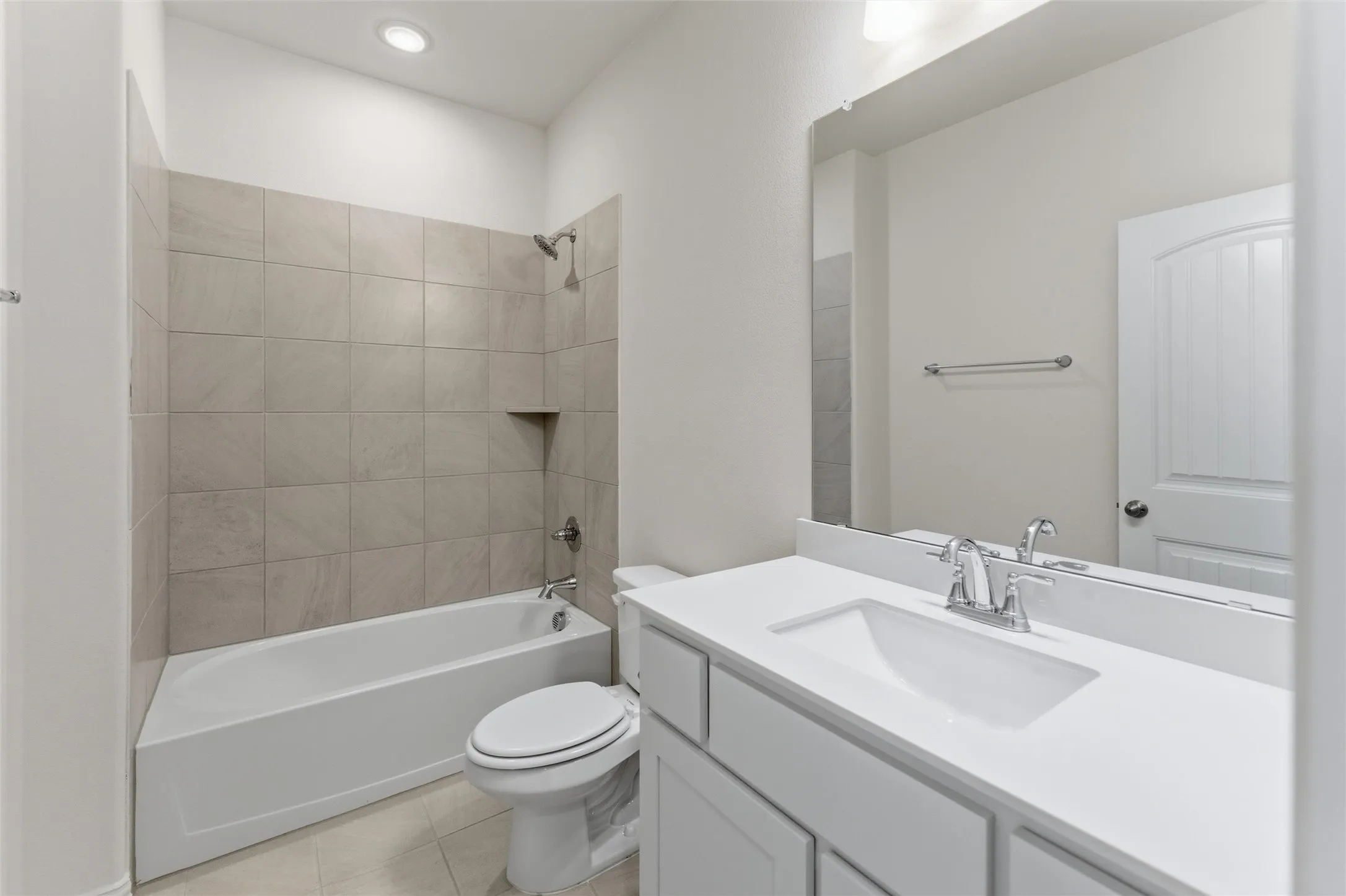 Full bathroom featuring vanity, shower / bath combination, and light tile patterned floors