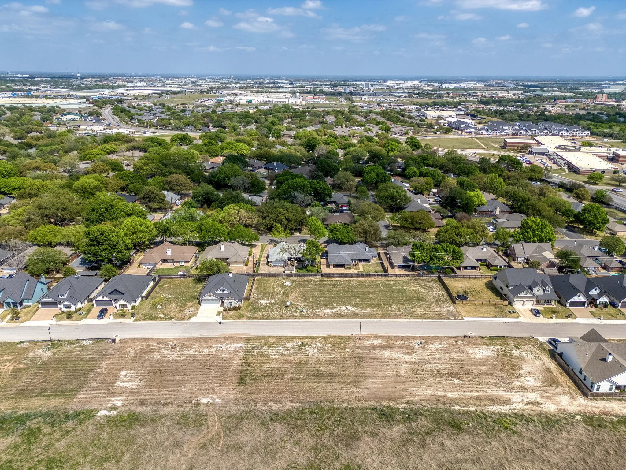 Aerial view of property's location with nearby suburban area