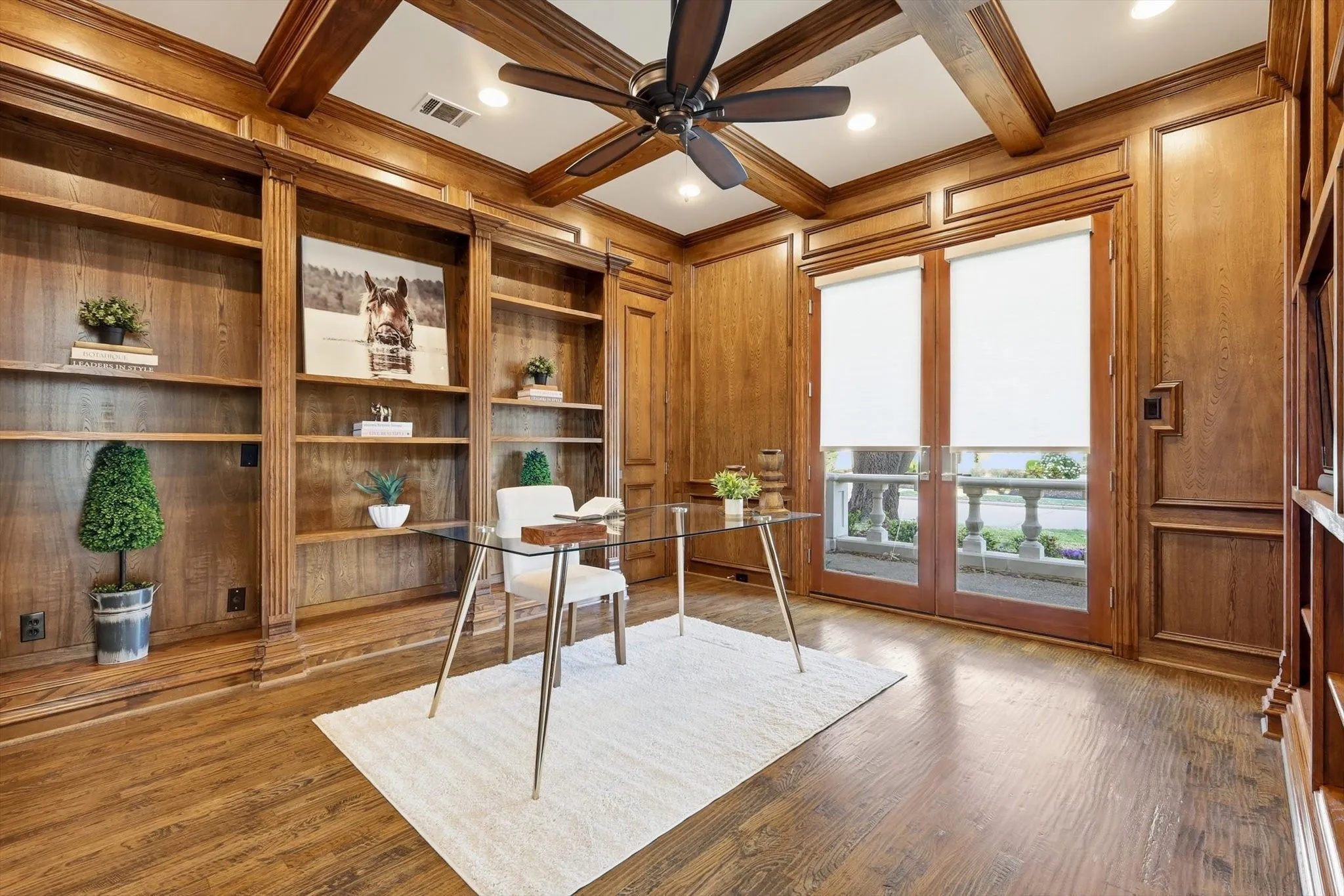 Large office with lockable closet on front of home with patio.