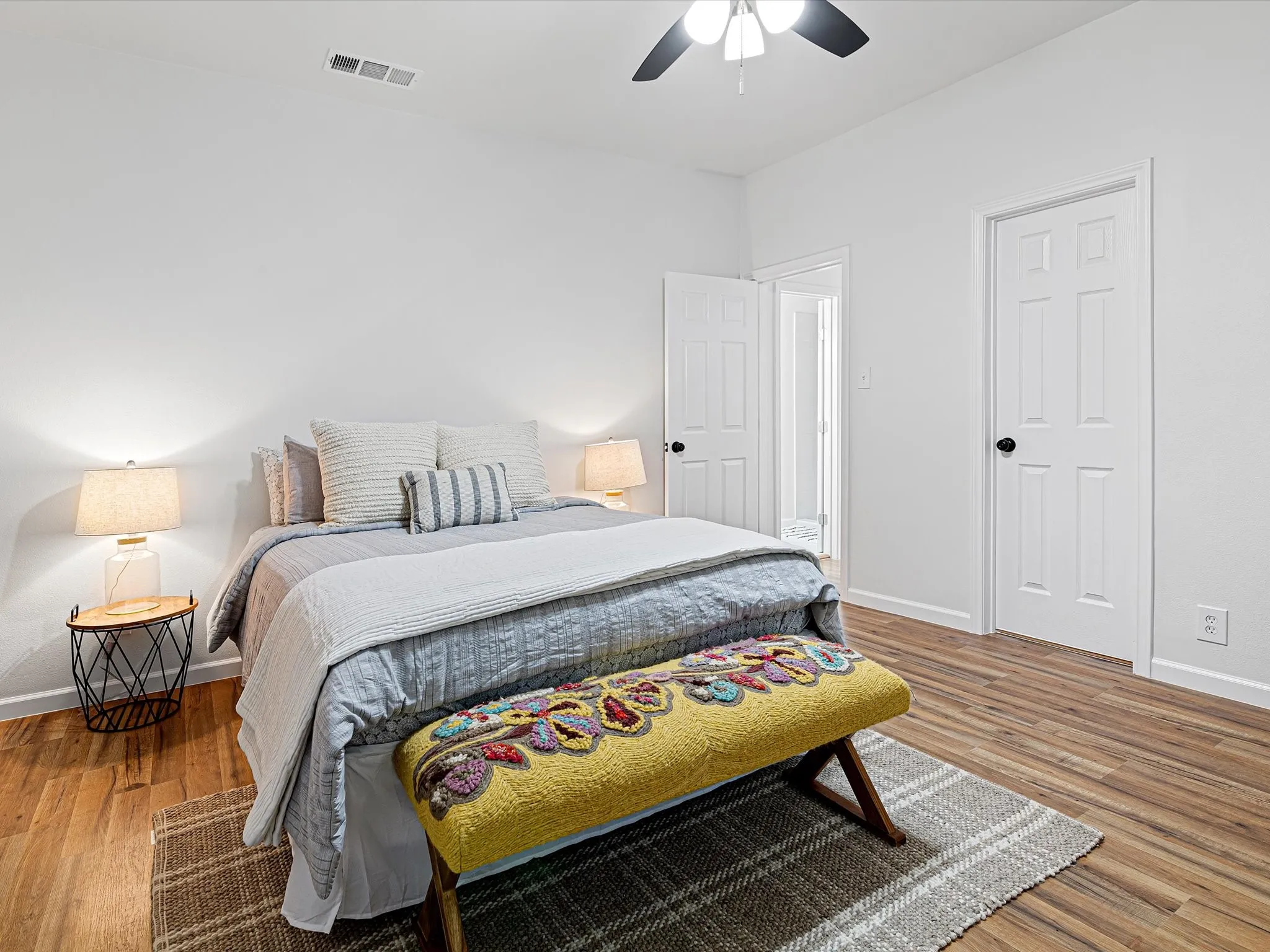 Primary bedroom is at the back of the front hall featuring LVP flooring, fresh paint, ceiling fan, ensuite full bathroom, etc.