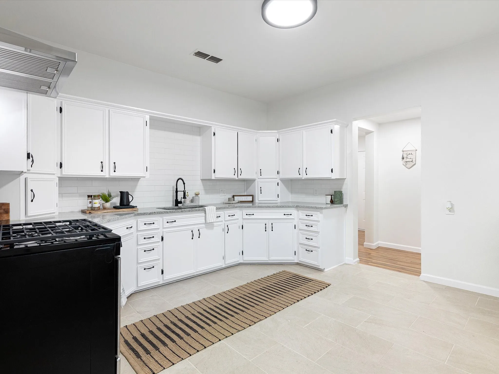 Kitchen has granite counter tops, ss appliances, lots of cabinets, added a dishwasher, large sink, updated fixtures and hardware, gas range, eat in area room enough for another table, and more!