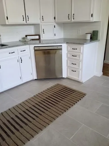 Added dishwasher. Washer/ dryer hook ups added in back room too to have utility on same level.