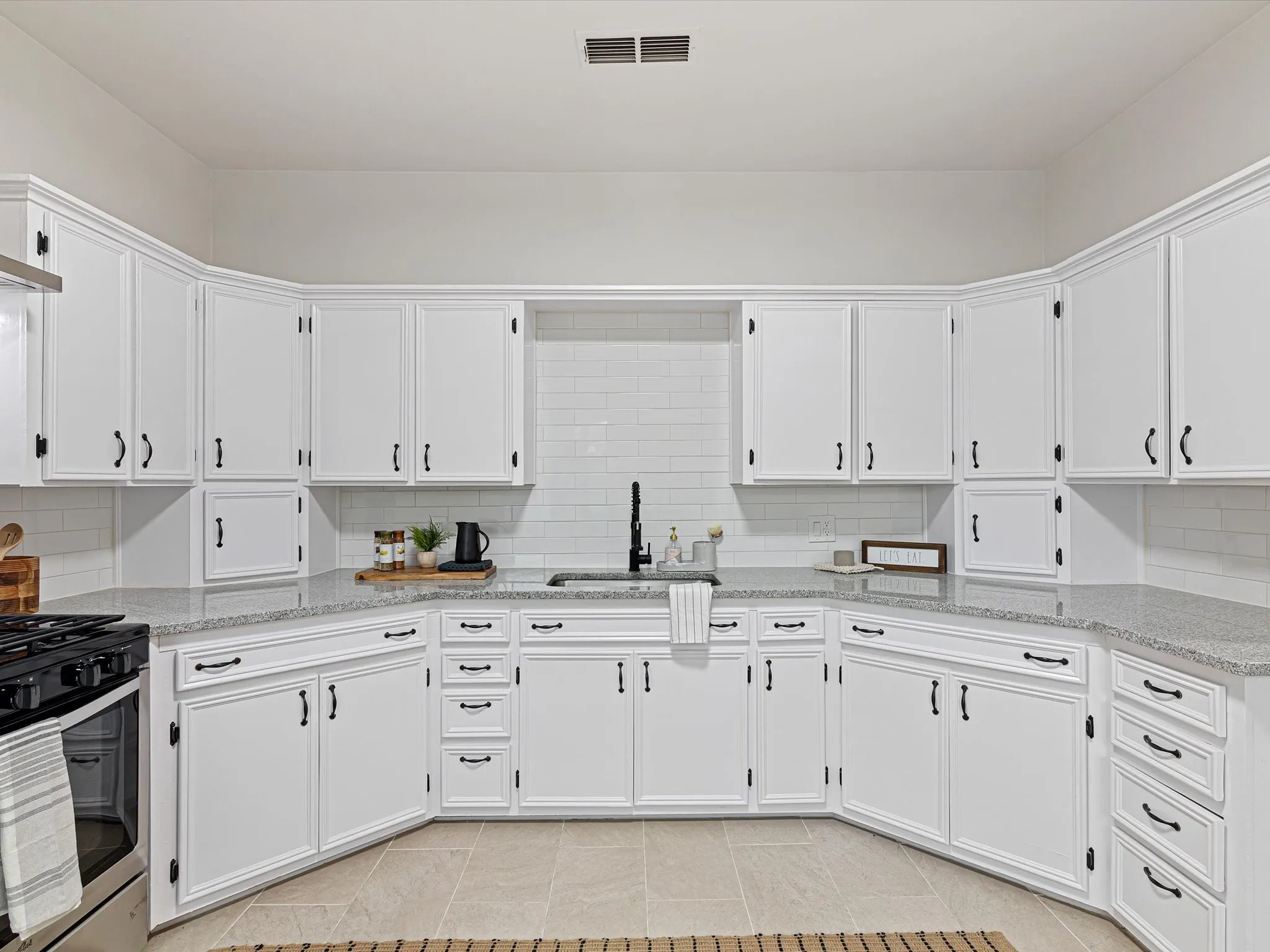 Kitchen has granite counter tops, ss appliances, lots of cabinets, added a dishwasher, large sink, updated fixtures and hardware, gas range, eat in area room enough for another table, and more!