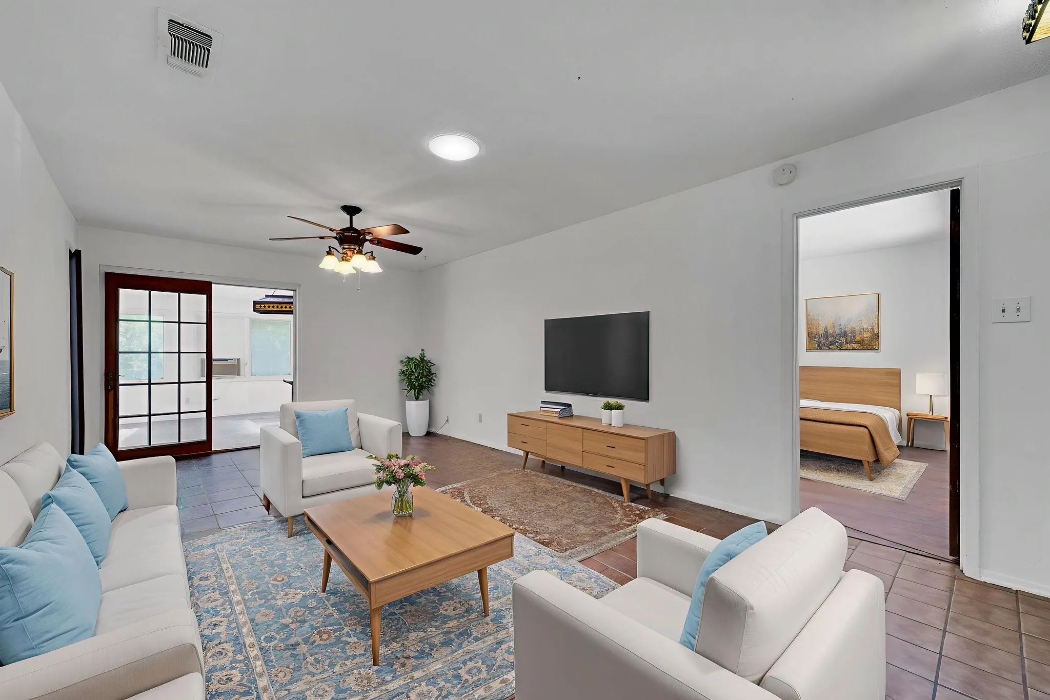 Living room with tile patterned floors and a ceiling fan