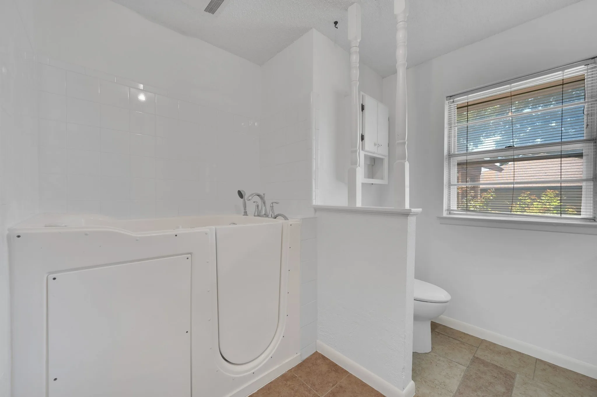 Bathroom with a bath and tile patterned flooring