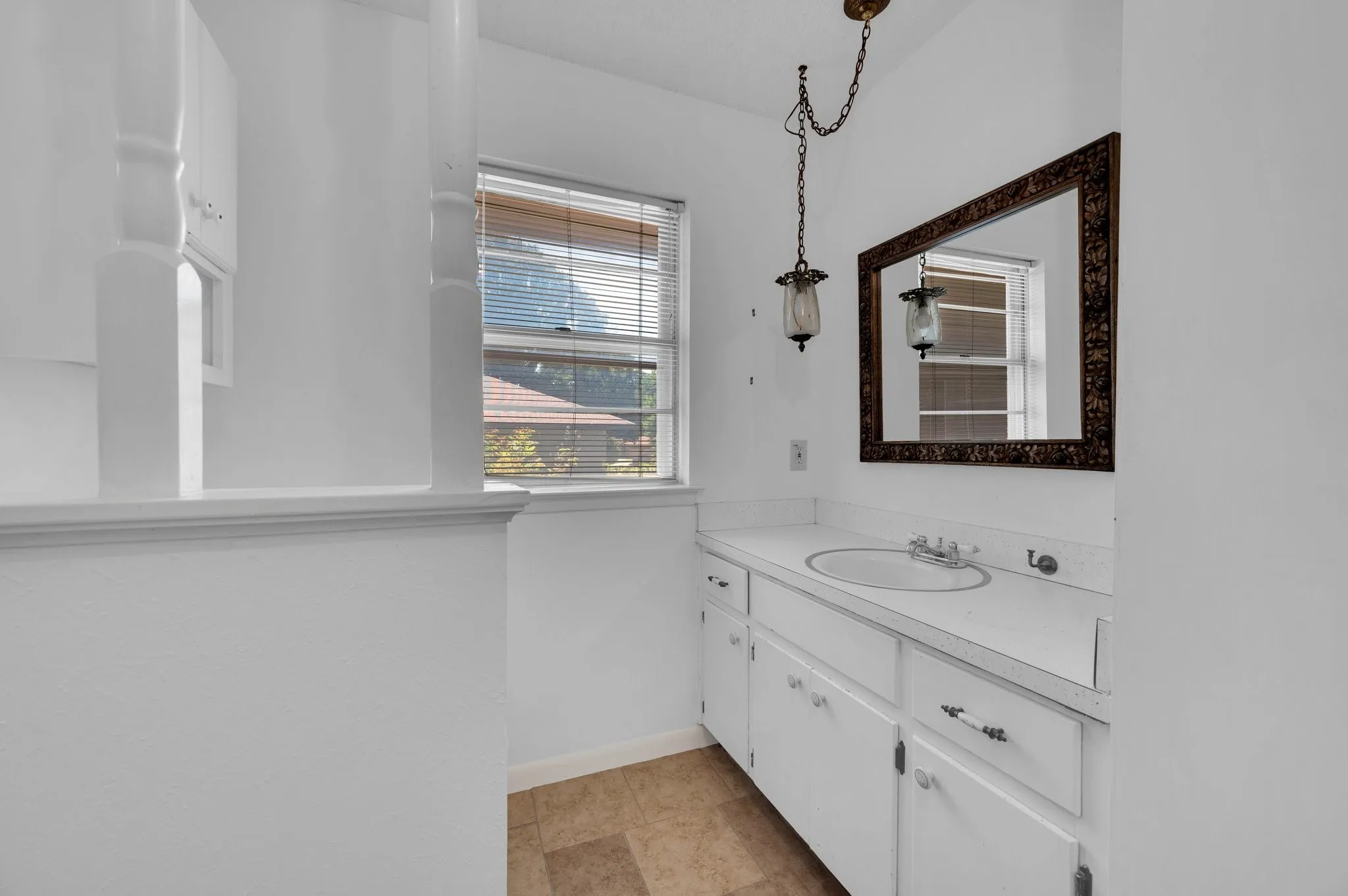 Bathroom with vanity and baseboards