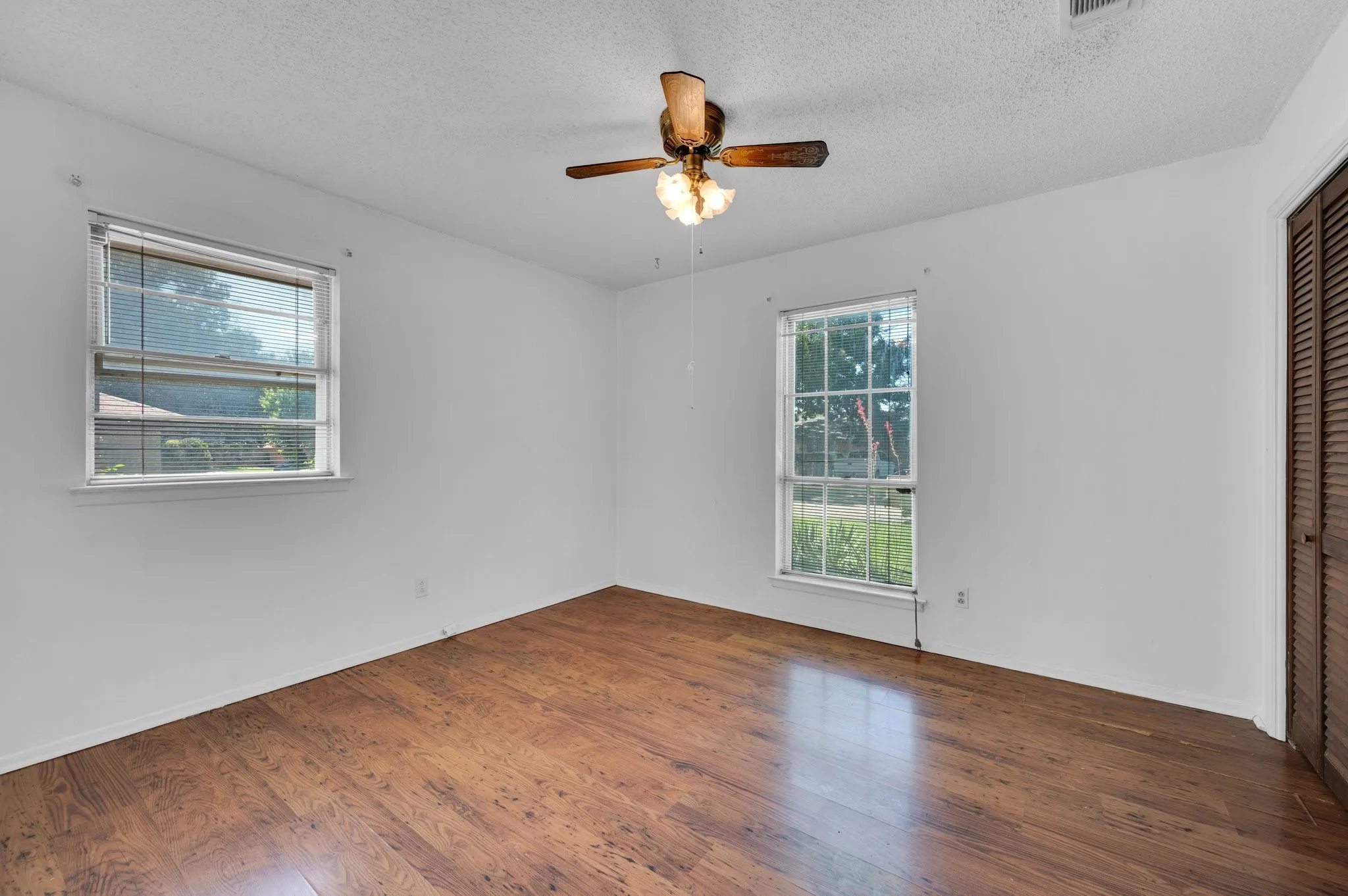Bedroom  2 with a ceiling fan, wood finished floors, and a textured ceiling