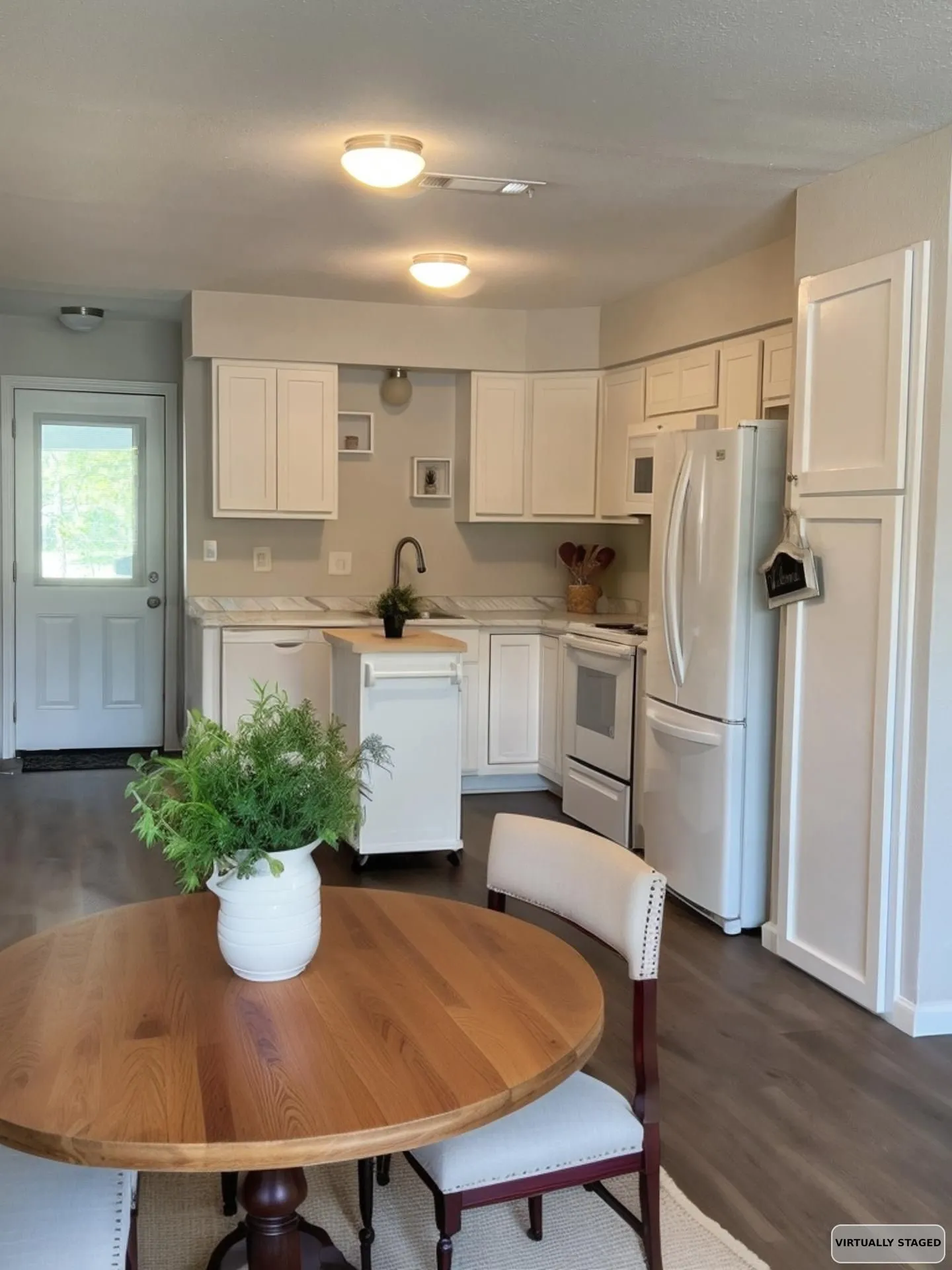 Eat-in Kitchen with light countertops, white appliances, and white cabinets