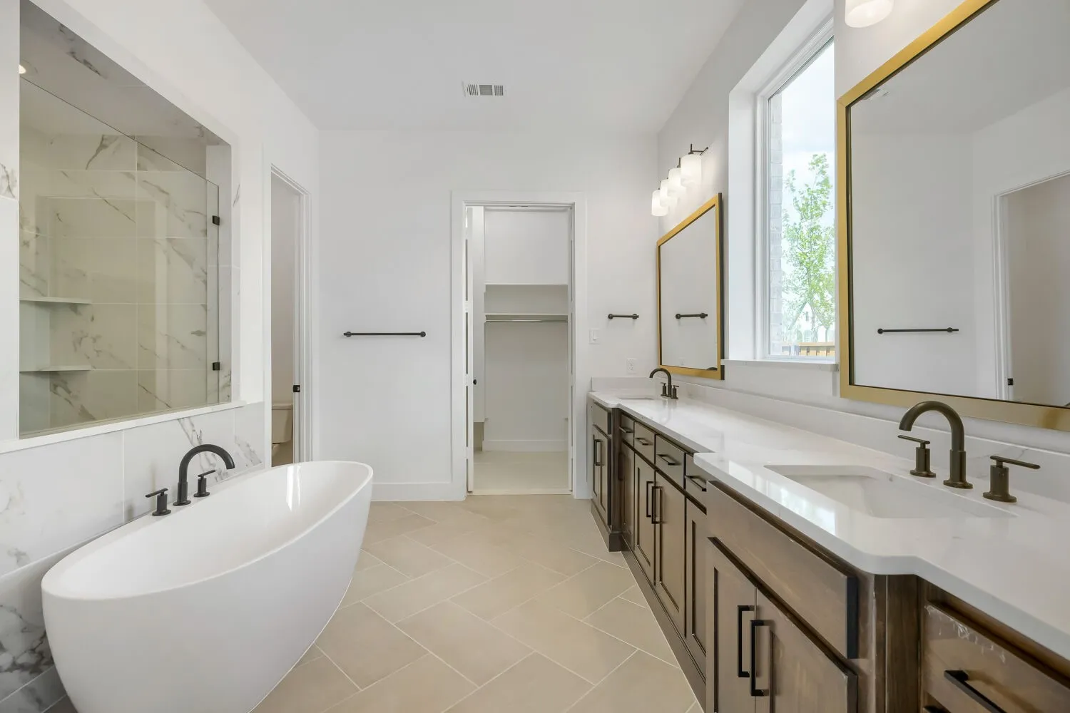 Modern bathroom featuring a freestanding tub and a spacious walk-in shower with stone-look tile