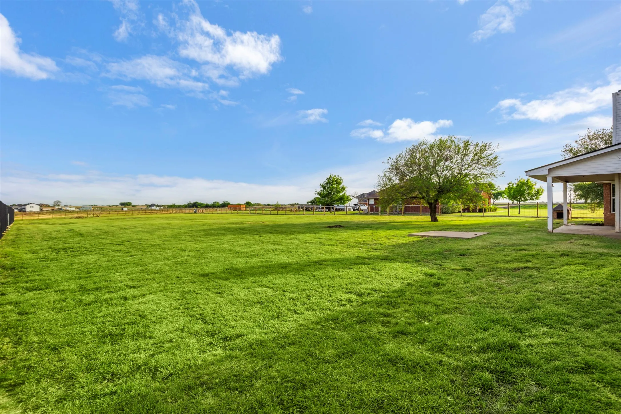 View of green lawn featuring a patio area