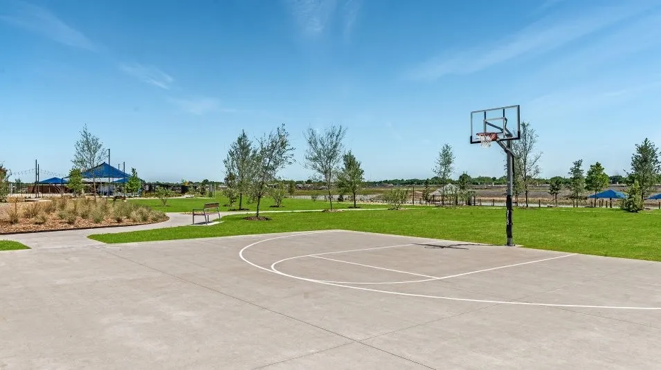 View of basketball court with a lawn and community basketball court