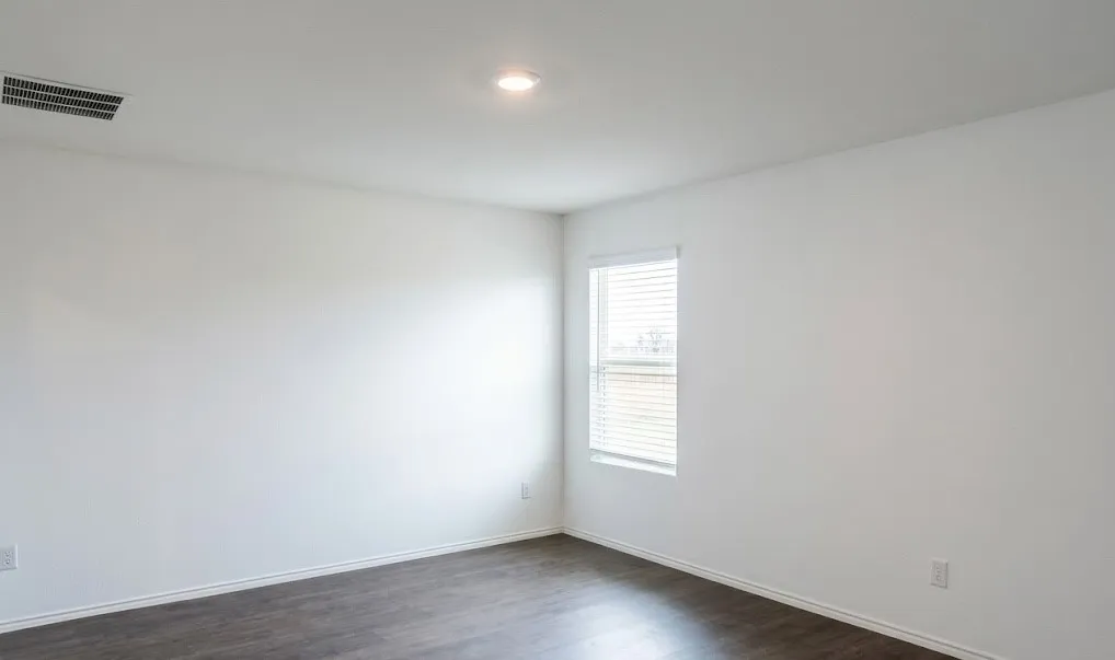 Spare room with dark wood finished floors and baseboards