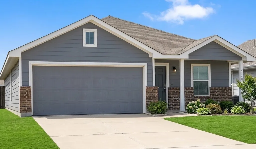 Single story home with brick siding, a garage, concrete driveway, and a front lawn