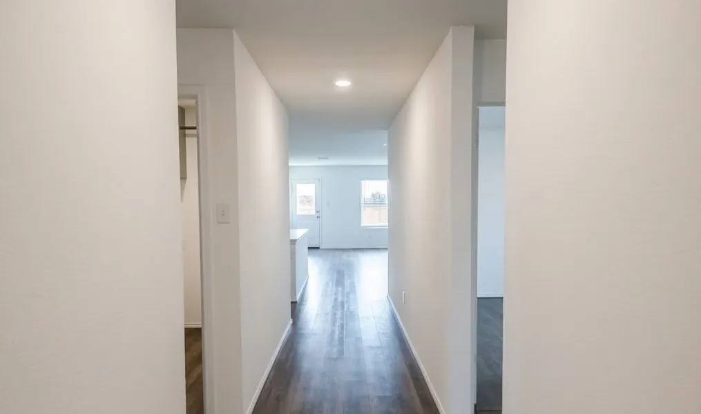 Hallway featuring dark wood-type flooring and recessed lighting